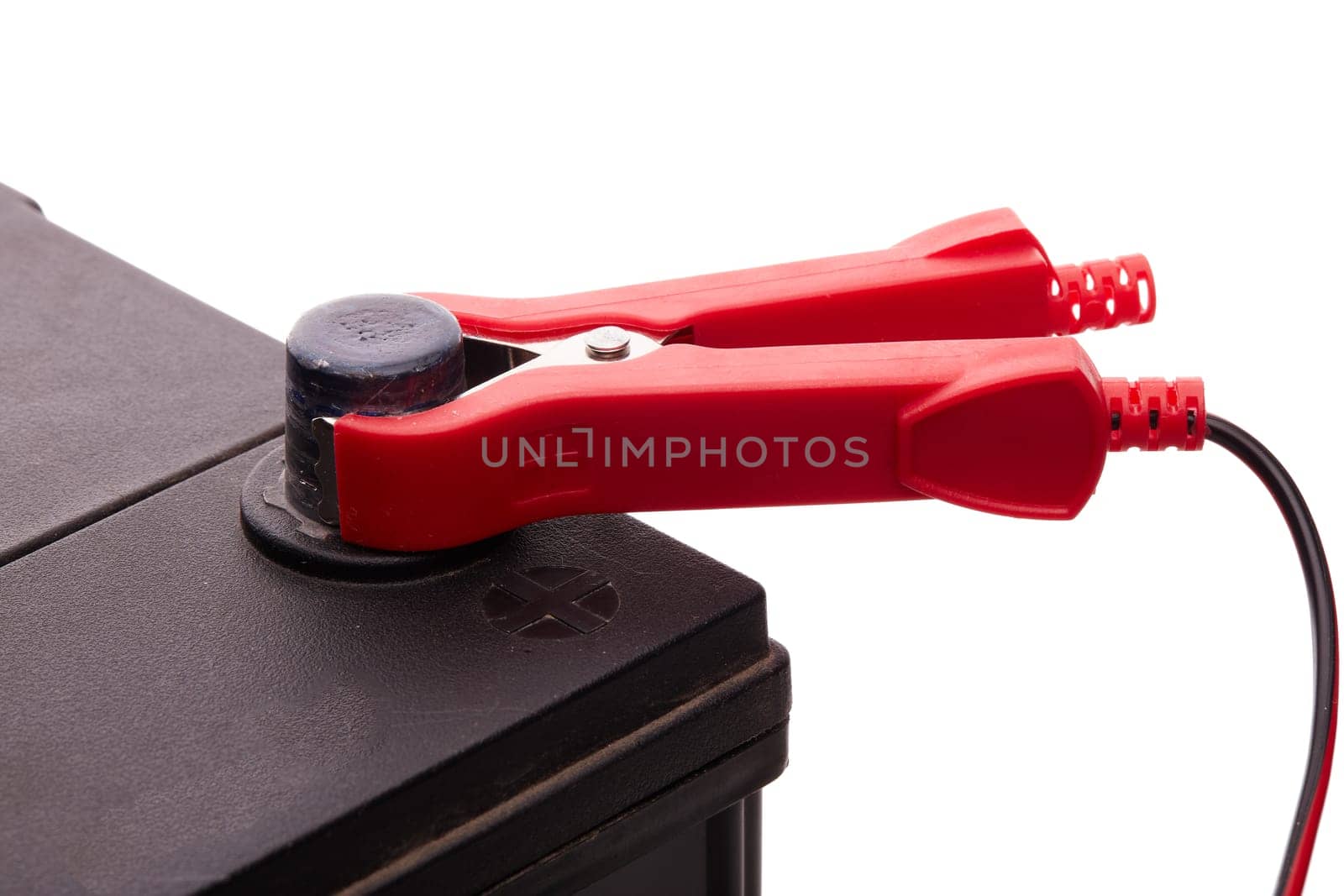 Black car accumulator battery and charger isolated on a white background. Acid battery,12 volts supply. Concept of service, maintenance, charging car battery, diy
