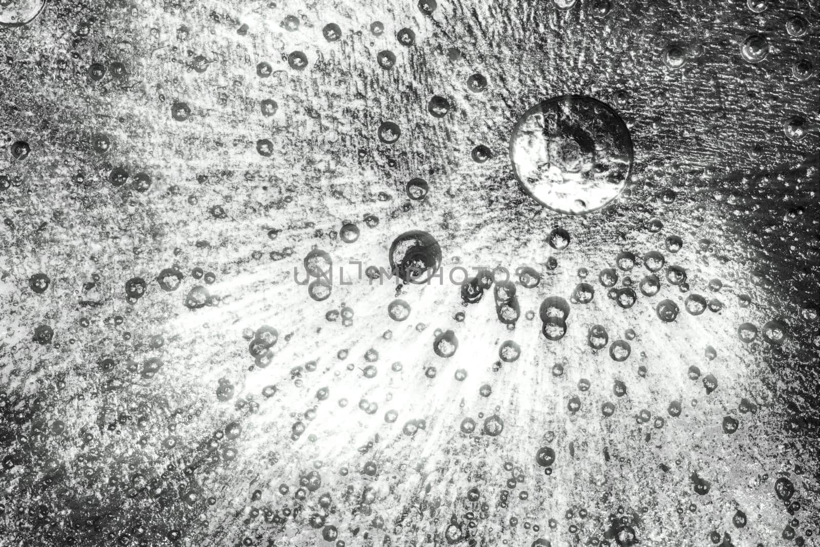 Frozen ice crystals with beautiful black and white. Large and small trapped air bubbles all across the ice.