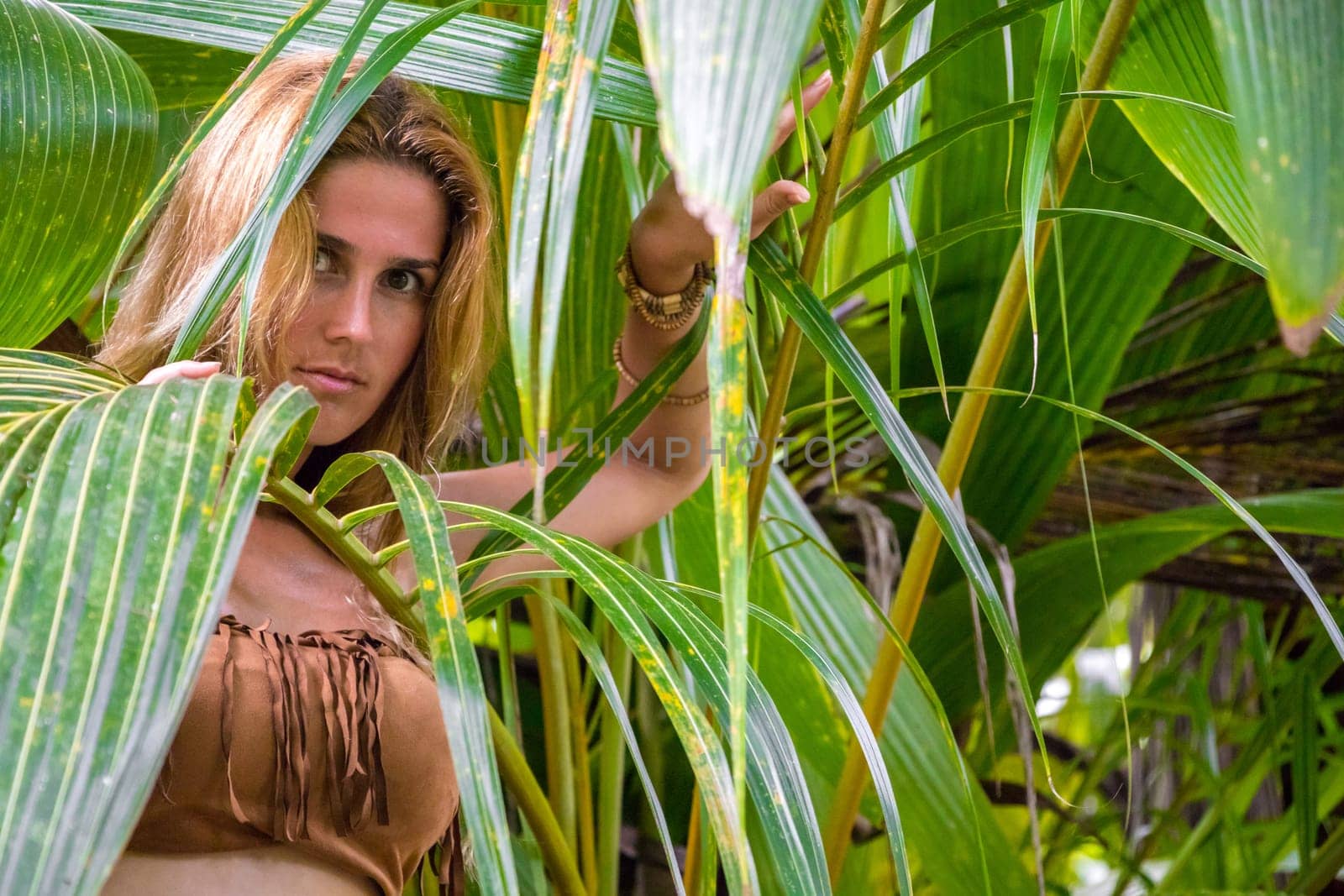 Wild woman hidden in the green jungle