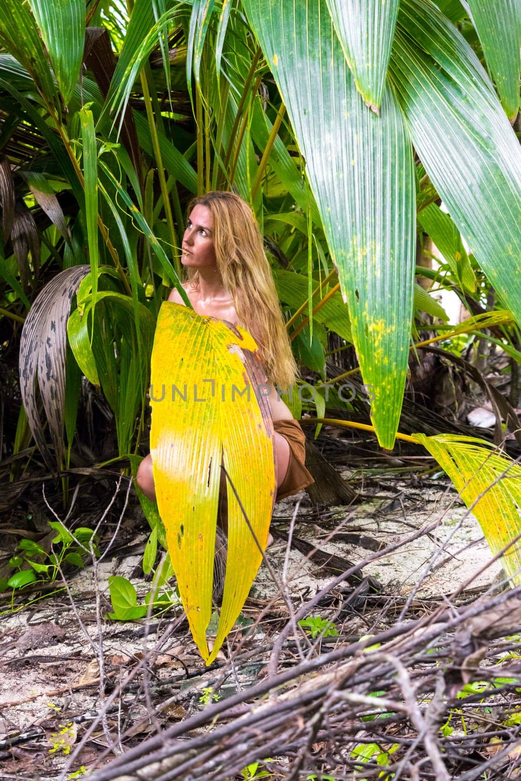 Wild woman hidden in the green jungle