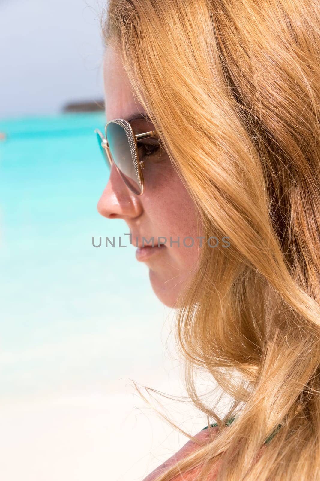Young girl sunbathing on the beach