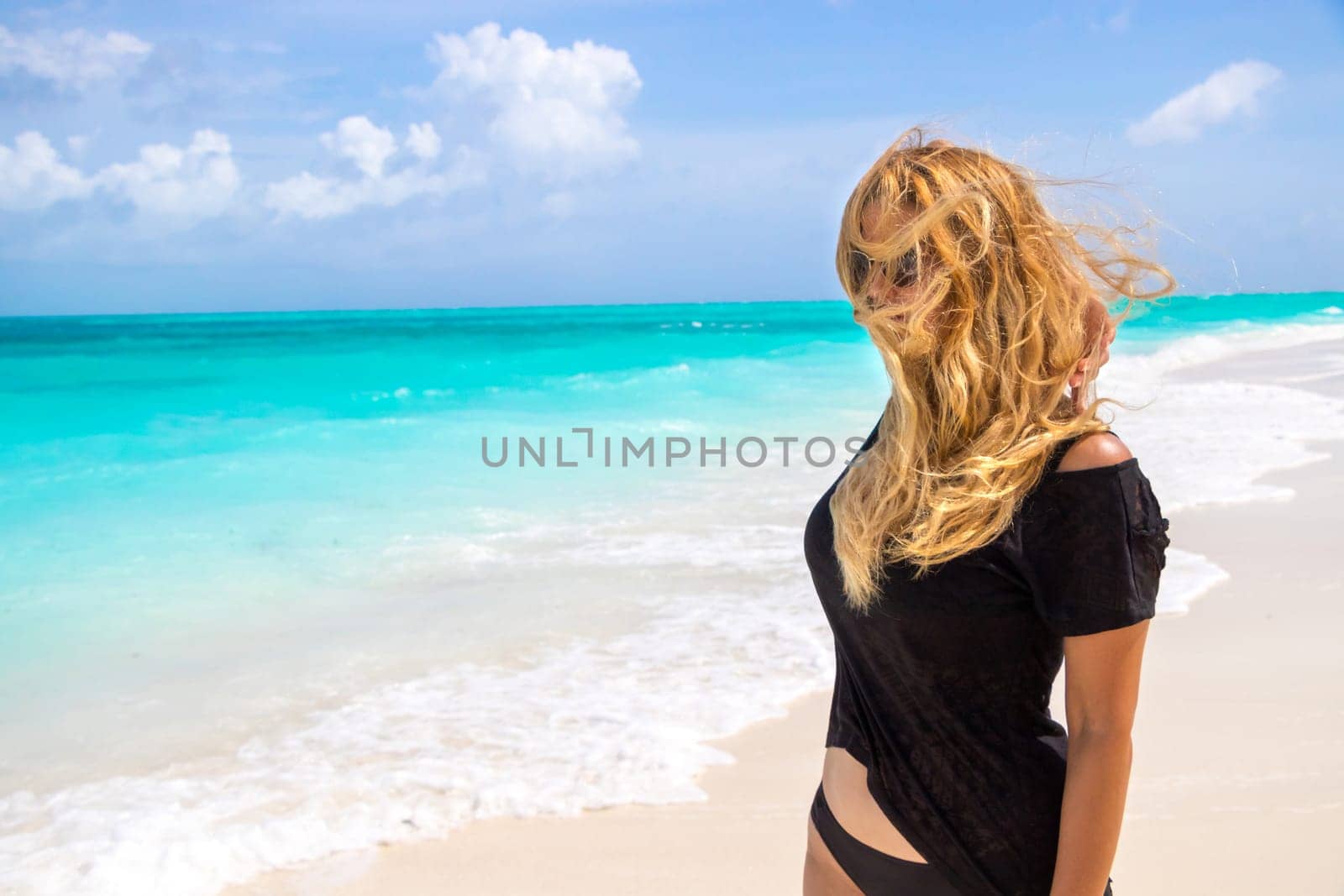 Happy young girl having fun at the dream beach