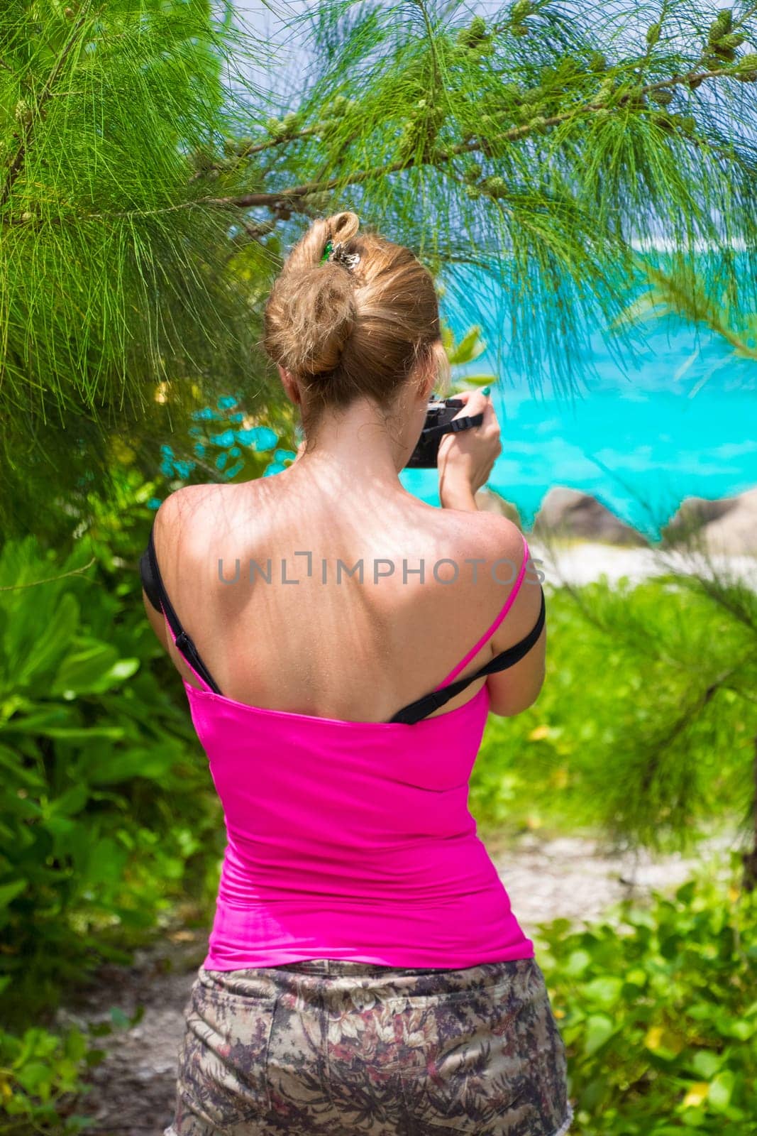 Young woman photographed on an idyllic beach