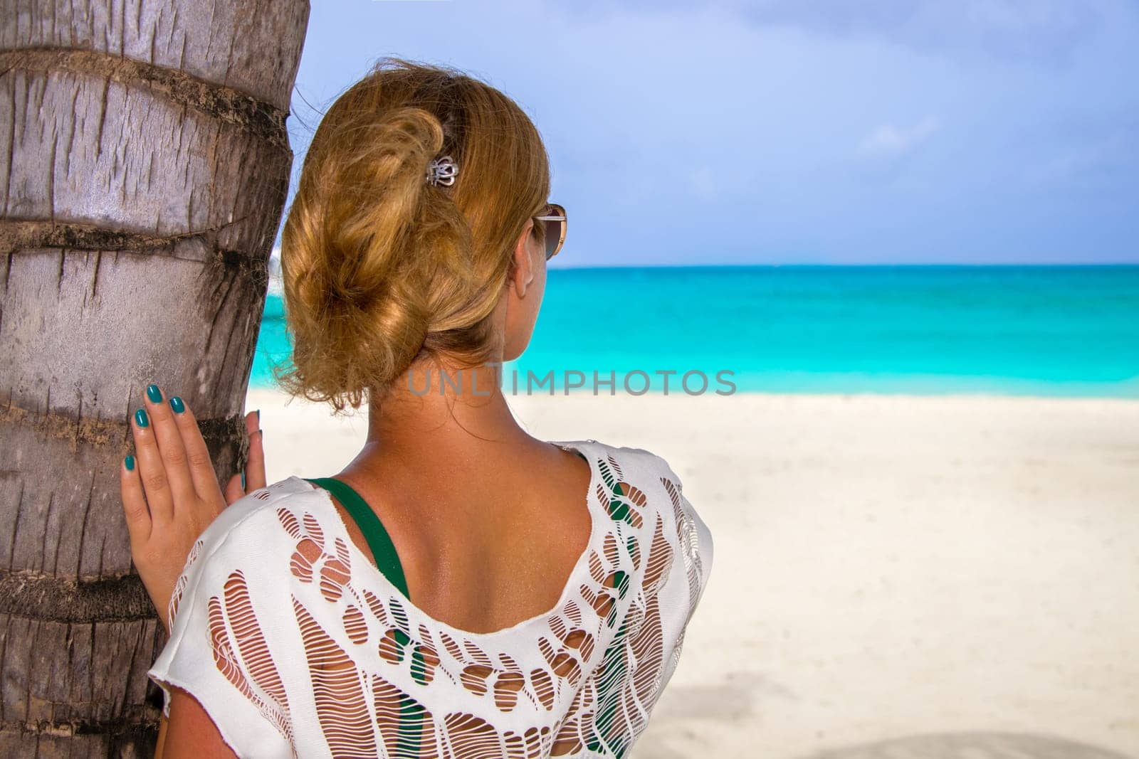 Beautiful woman under palm tree