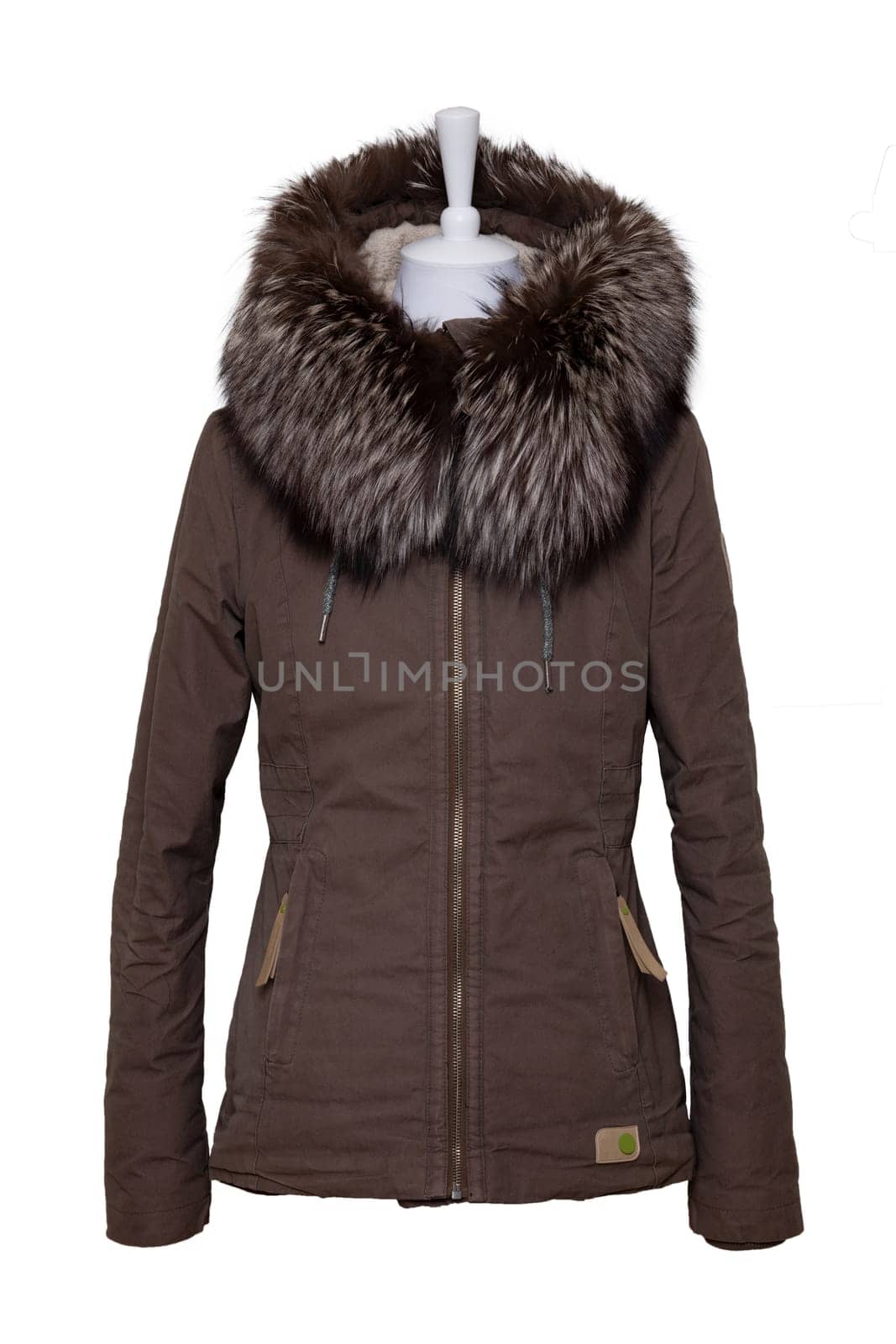 Woman clothes. Stylish brown female winter jacket with fur hood on mannequin isolated on a white background. Winter fashion.