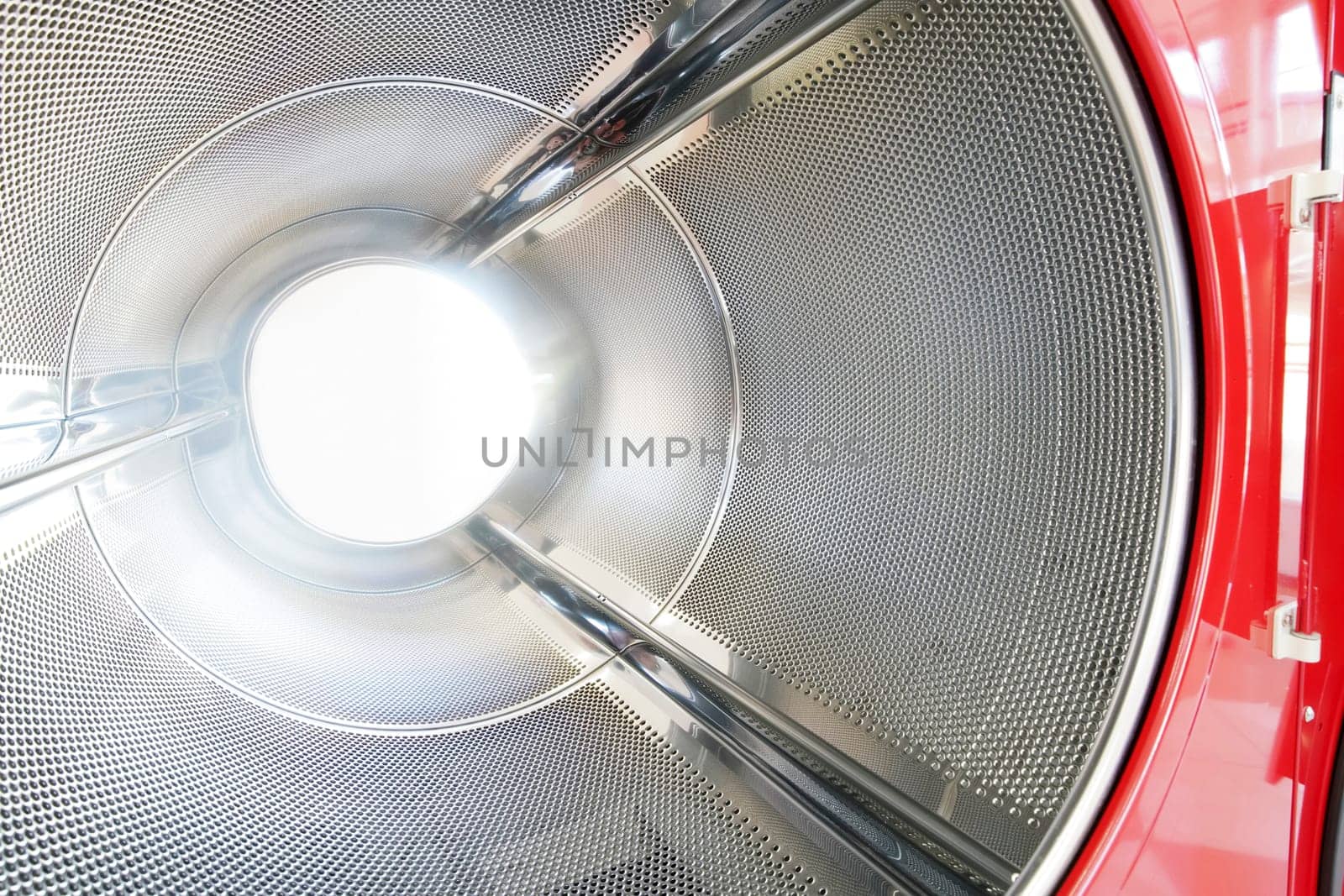 close up of industrial laundry machine in a public laundromat