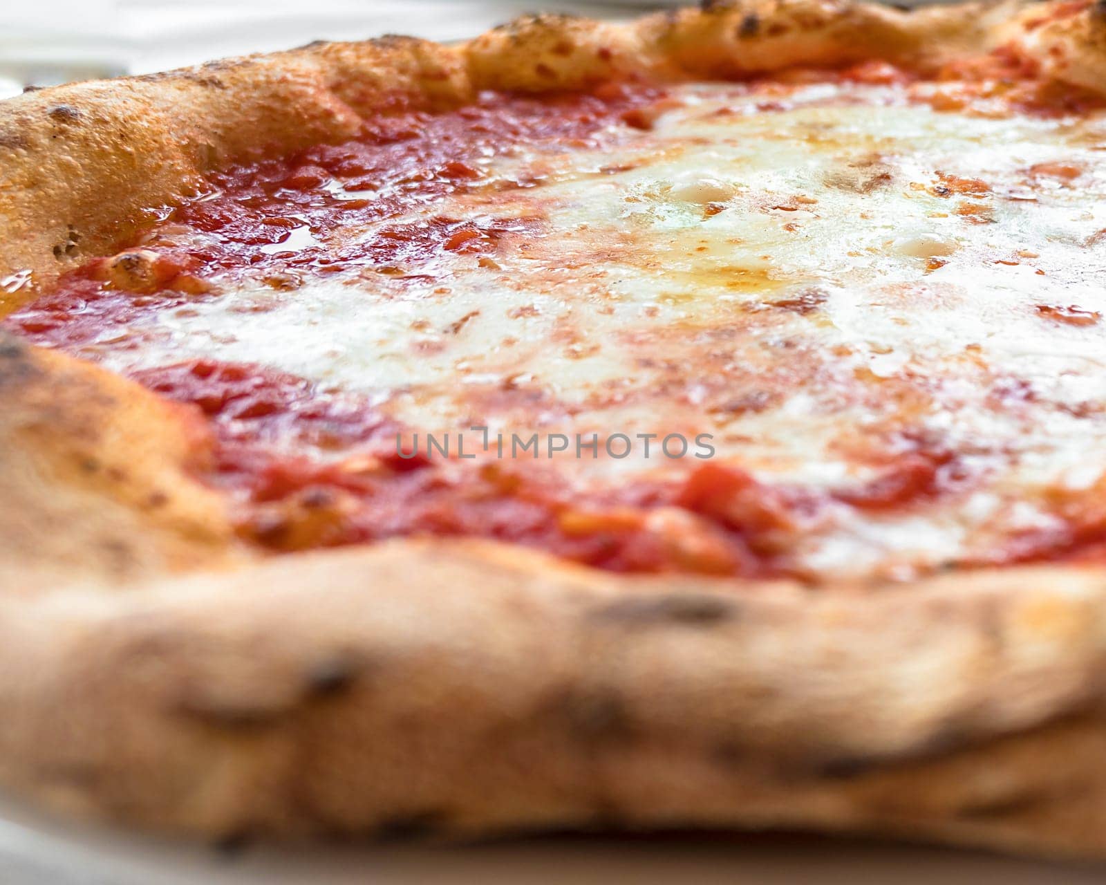 Italy. Real Pizza Margherita cooked in a wood oven. Shallow DOF.