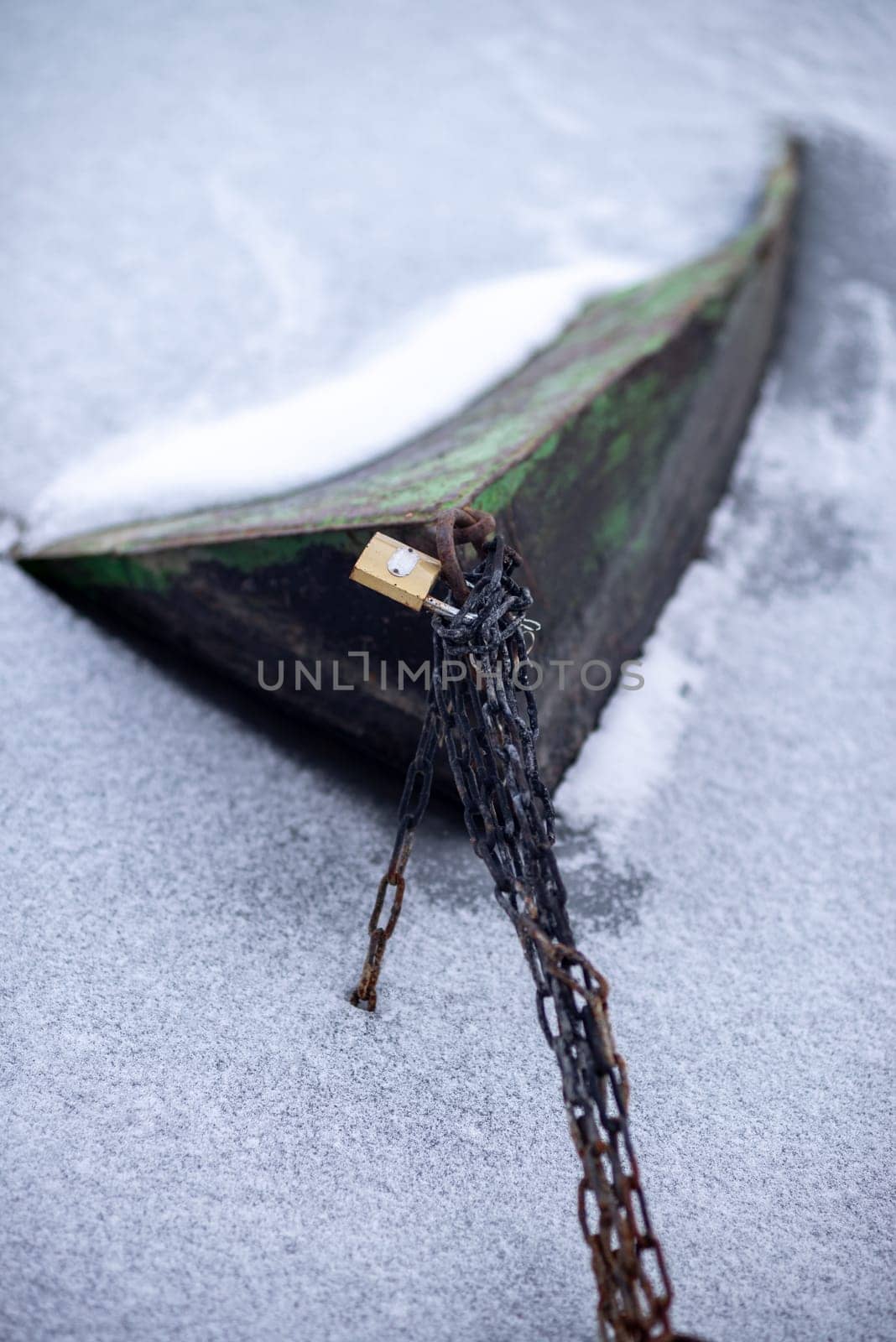Boat frozen in ice at winter