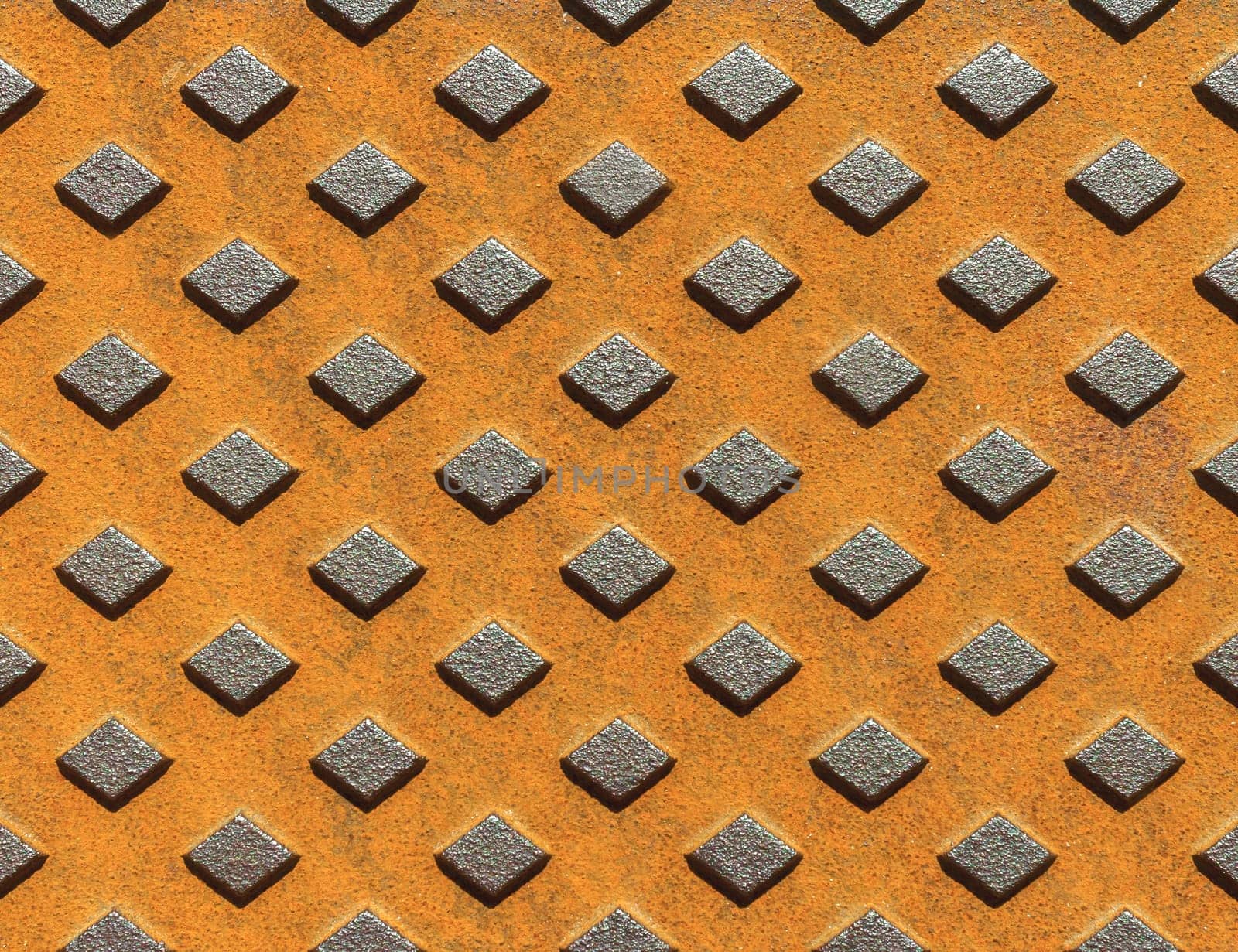 Manhole fragment. Metal rusty texture with geometric pattern.