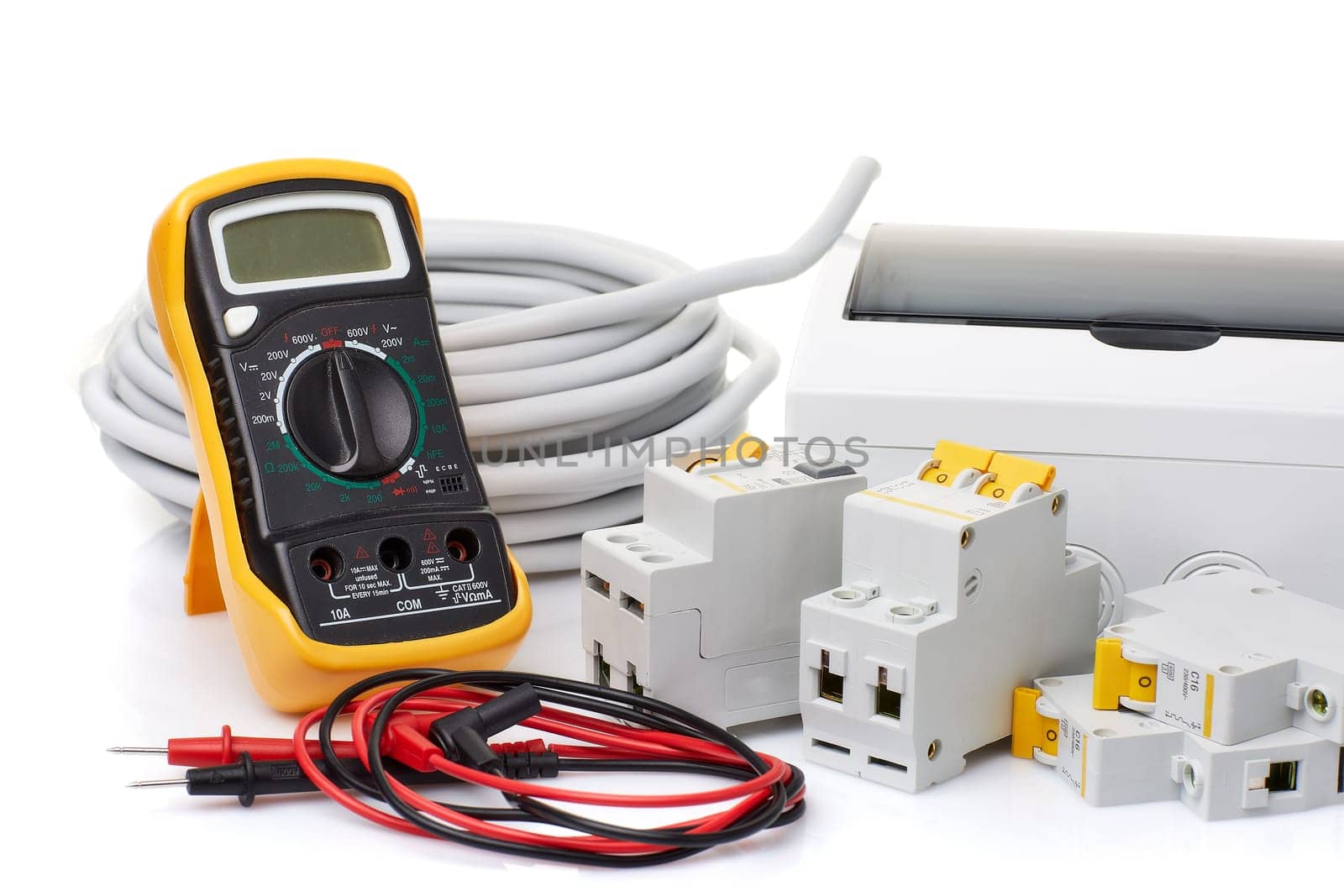 Automatic circuit breakers, distribution box, cable and digital multimeter on a white background. Electrical equipment. Accessories for electrical protection and control
