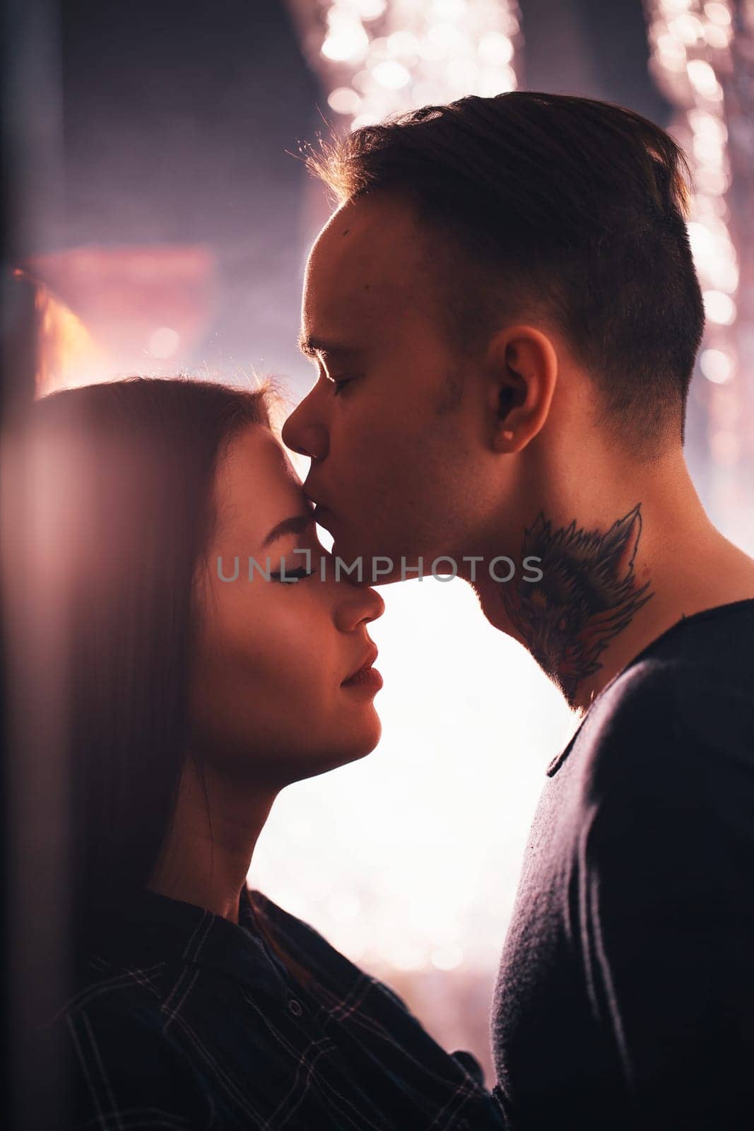 guy and the girl kiss closeup on a light background