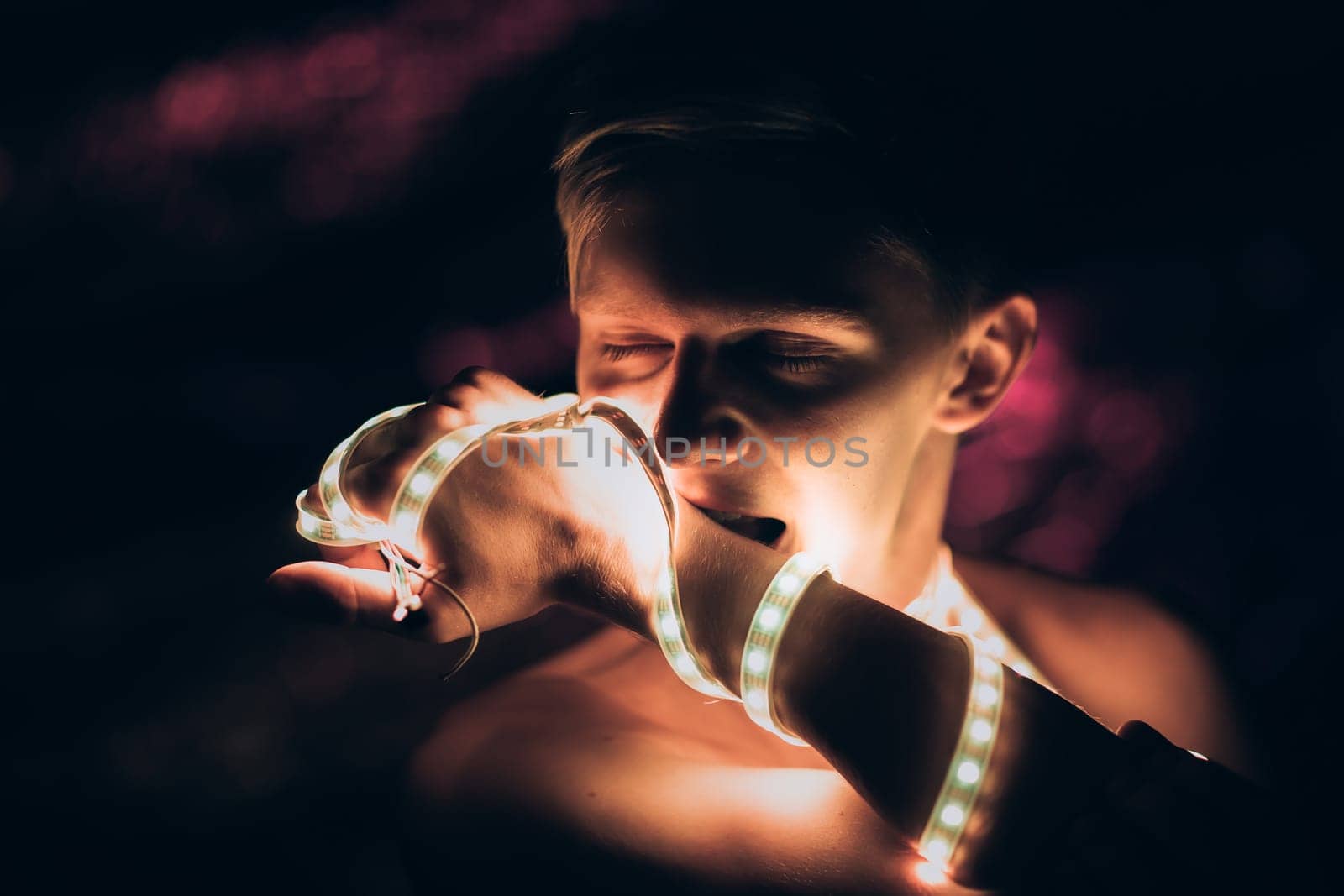 Portrait man Strip Light LED tape on dark color background.