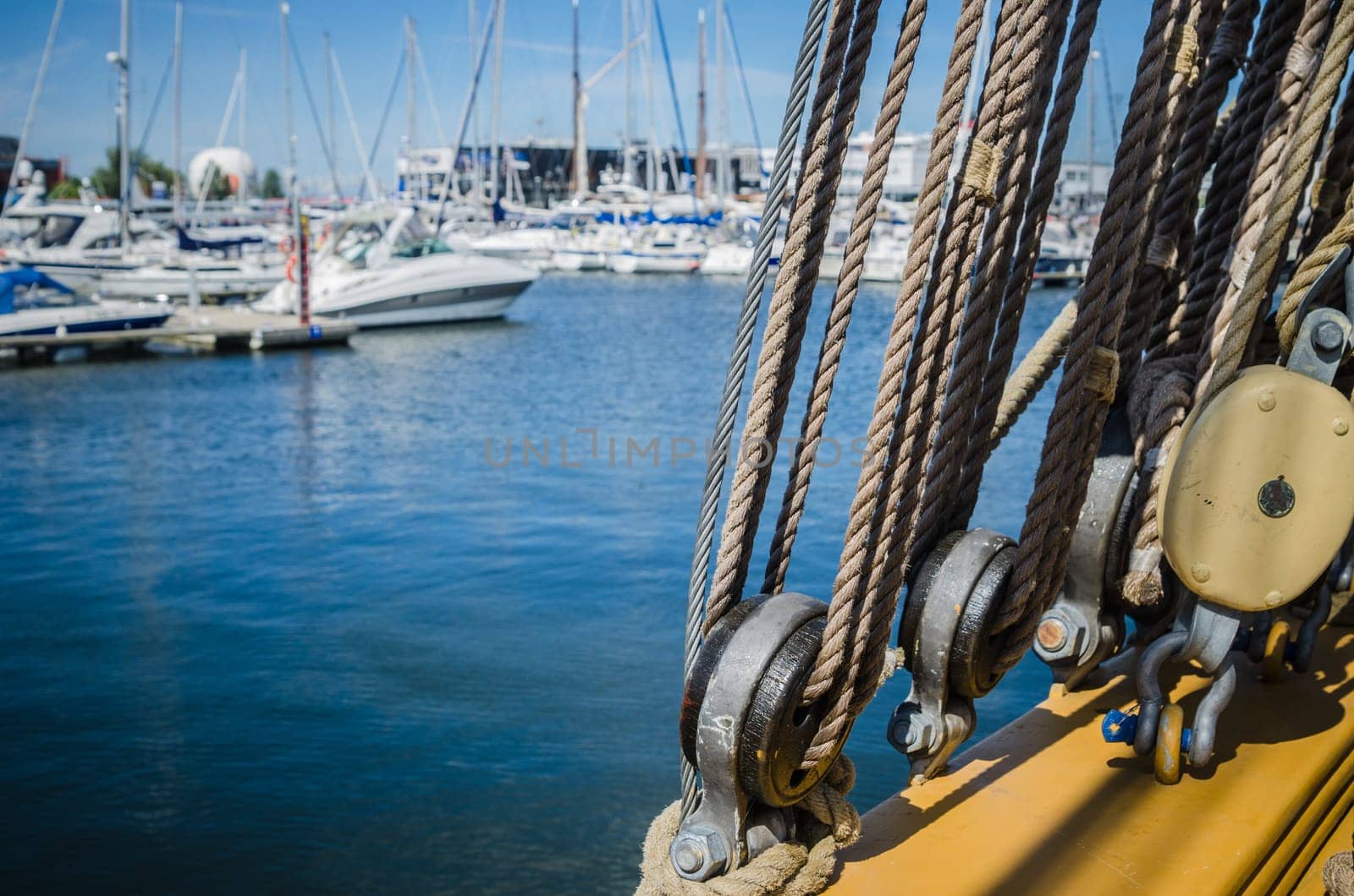 Rigging on the old sailboat against the background of modern yachts