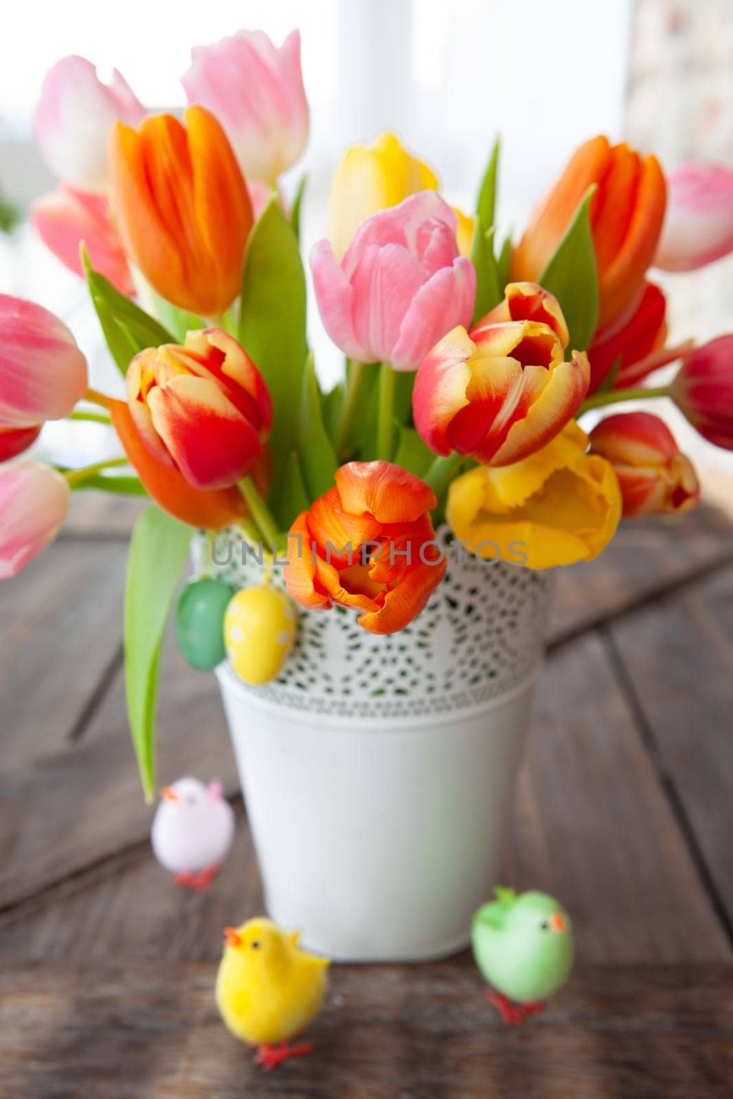 Bunch of fresh colorful tulips with easter decorations