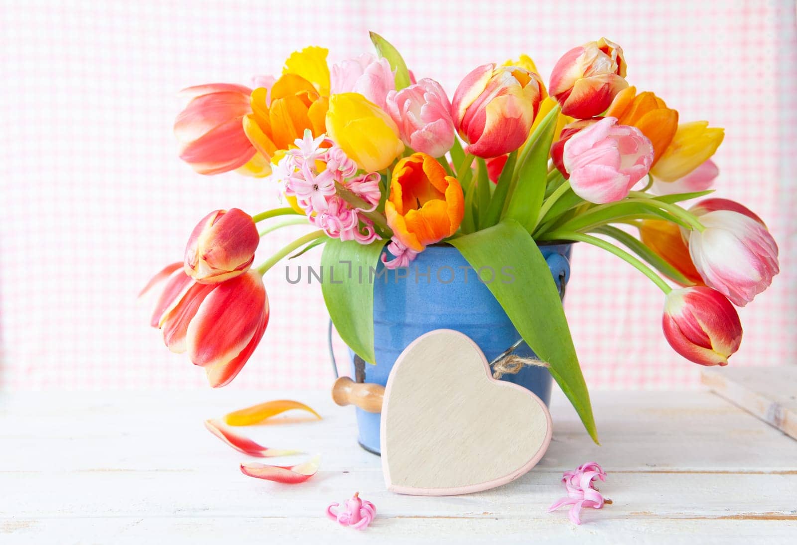 Bunch of fresh colorful tulips and a little heart