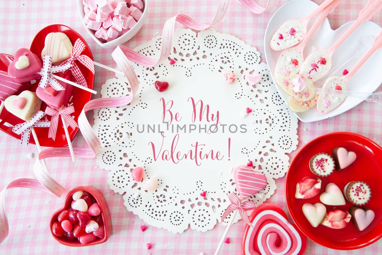 Yummy sweets and chocolates in a heart shape and pink