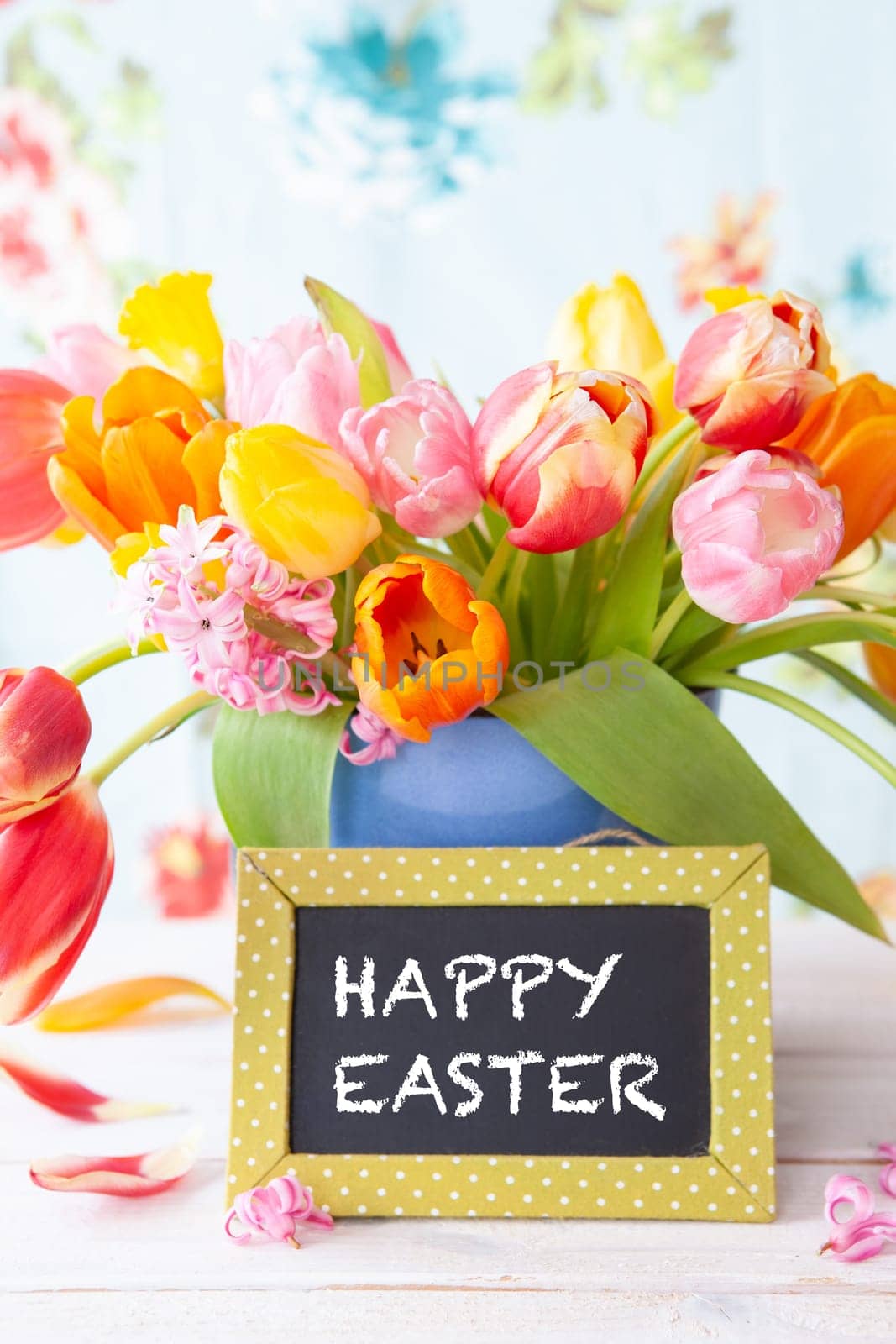 Bunch of fresh colorful tulips and y chalkboard with copy space