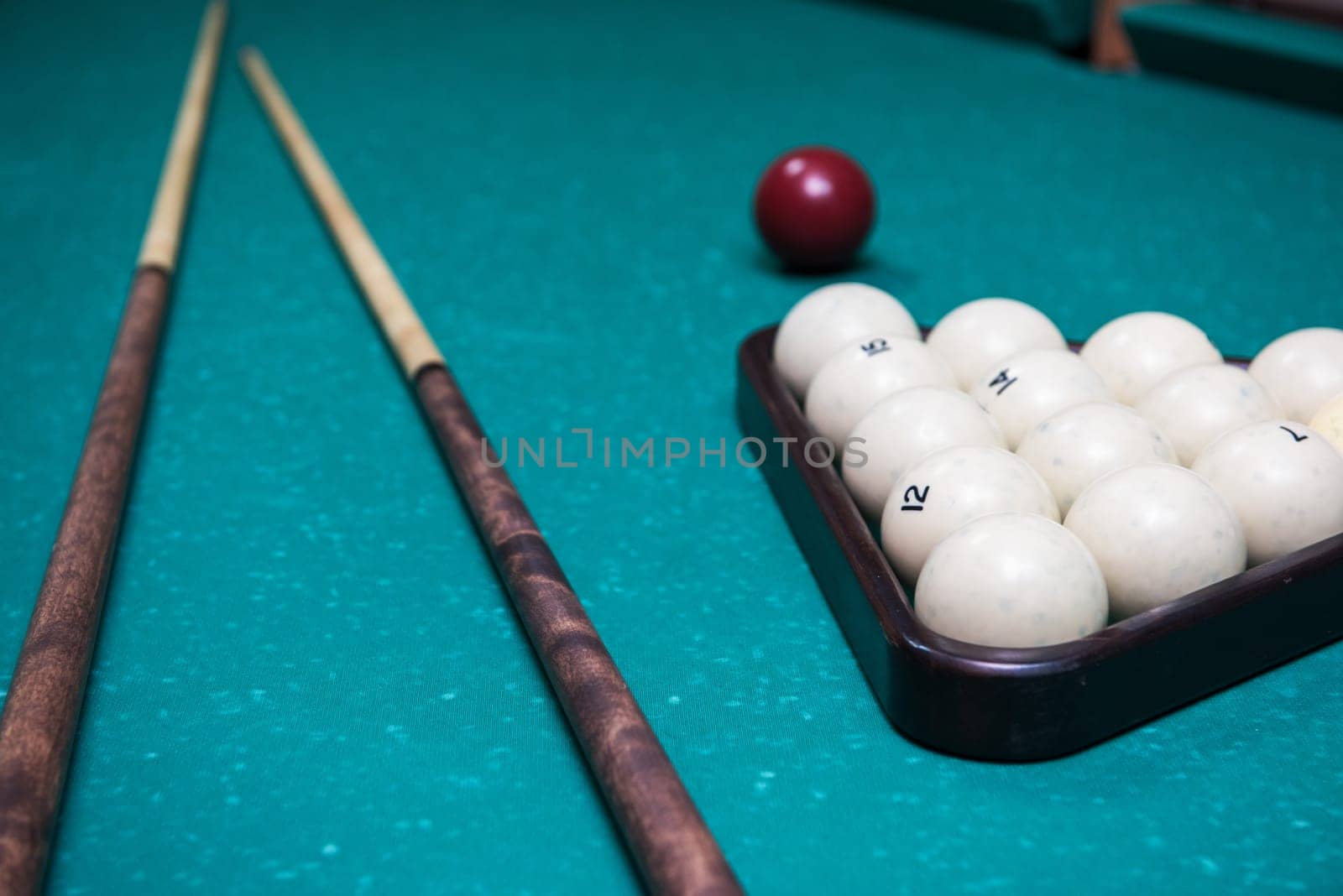 Russian billiard table with balls and cue sticks on a green background