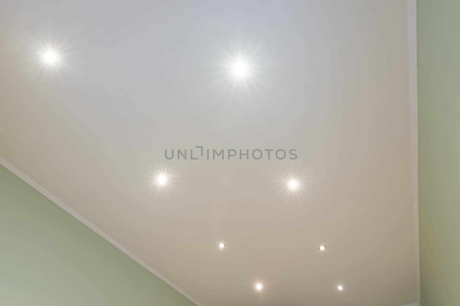 Ceiling in the room with spotlights installed and turned on