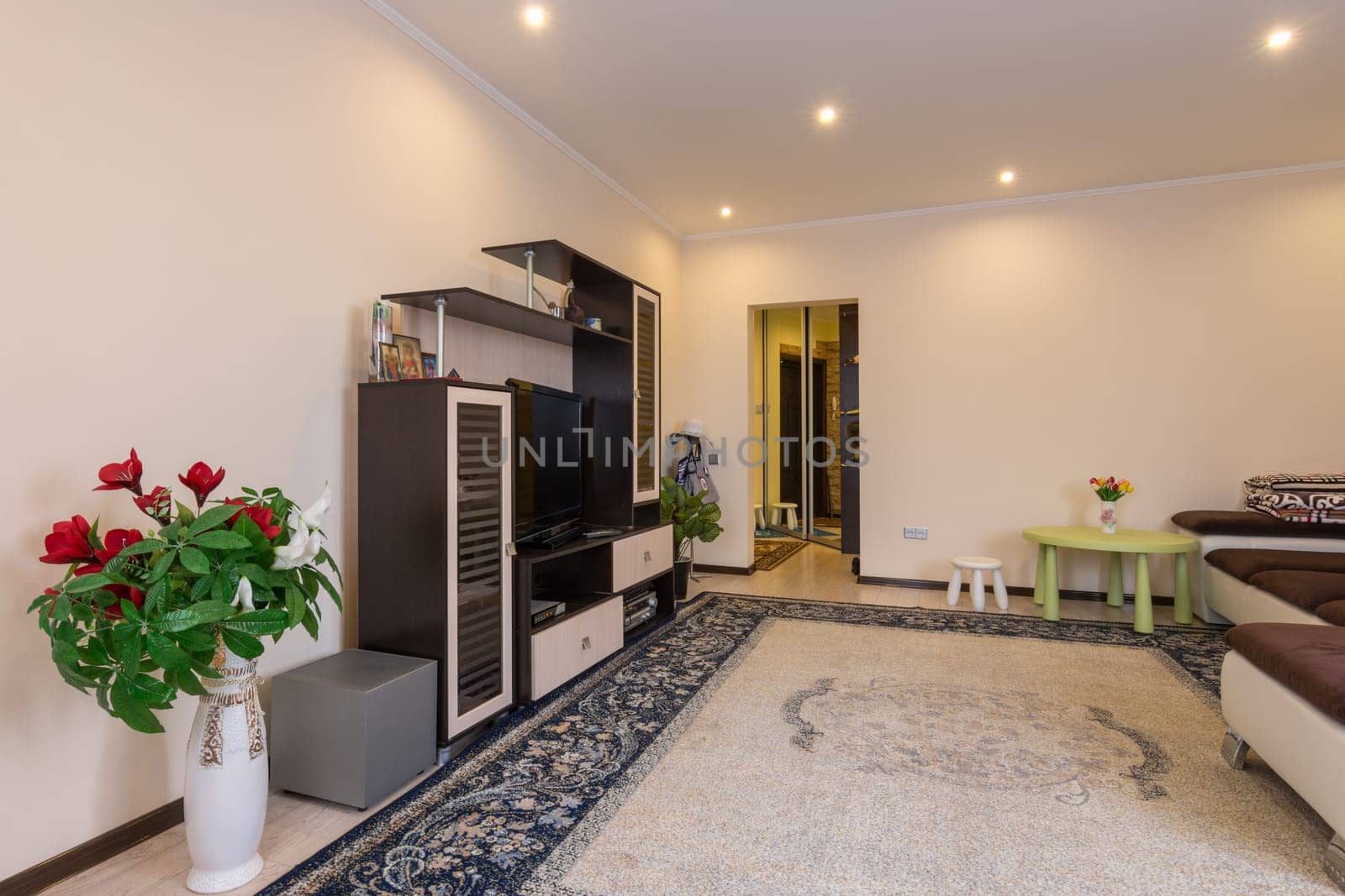 The interior of a spacious living room, entrance from the hallway