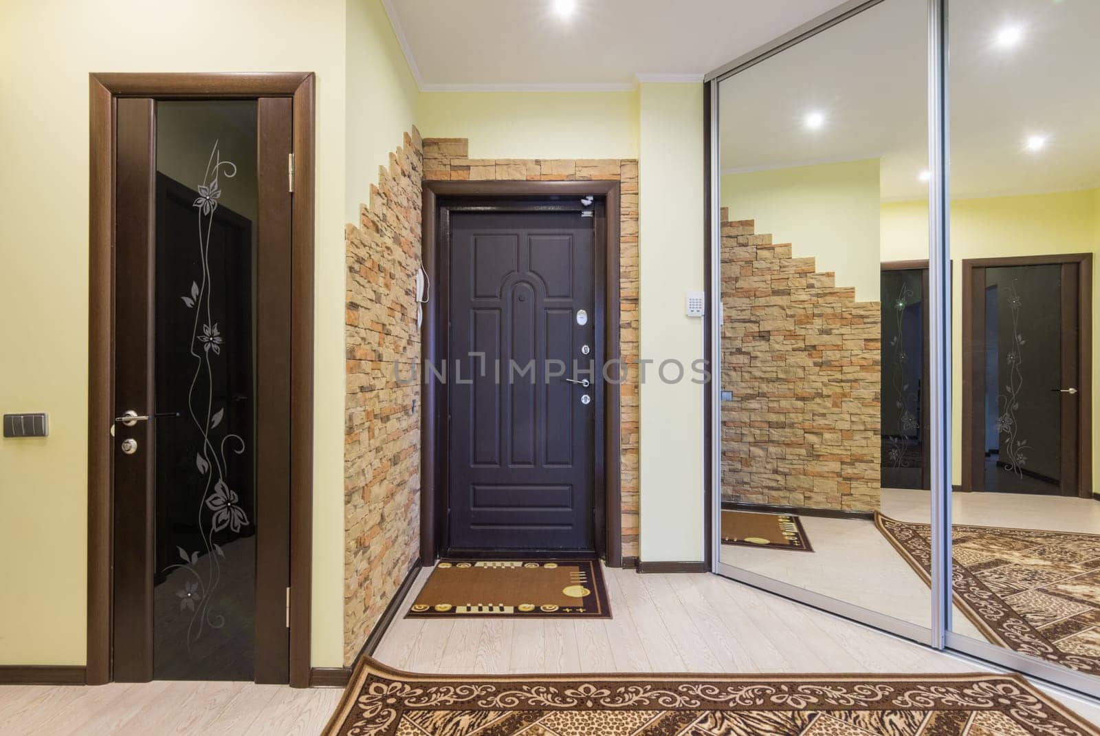 Spacious entrance hall in the apartment with built-in wardrobe and mirrors
