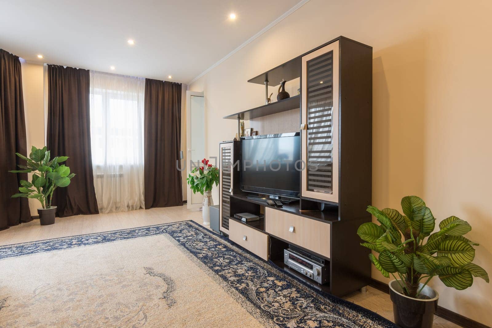 The interior of a spacious living room in the apartment