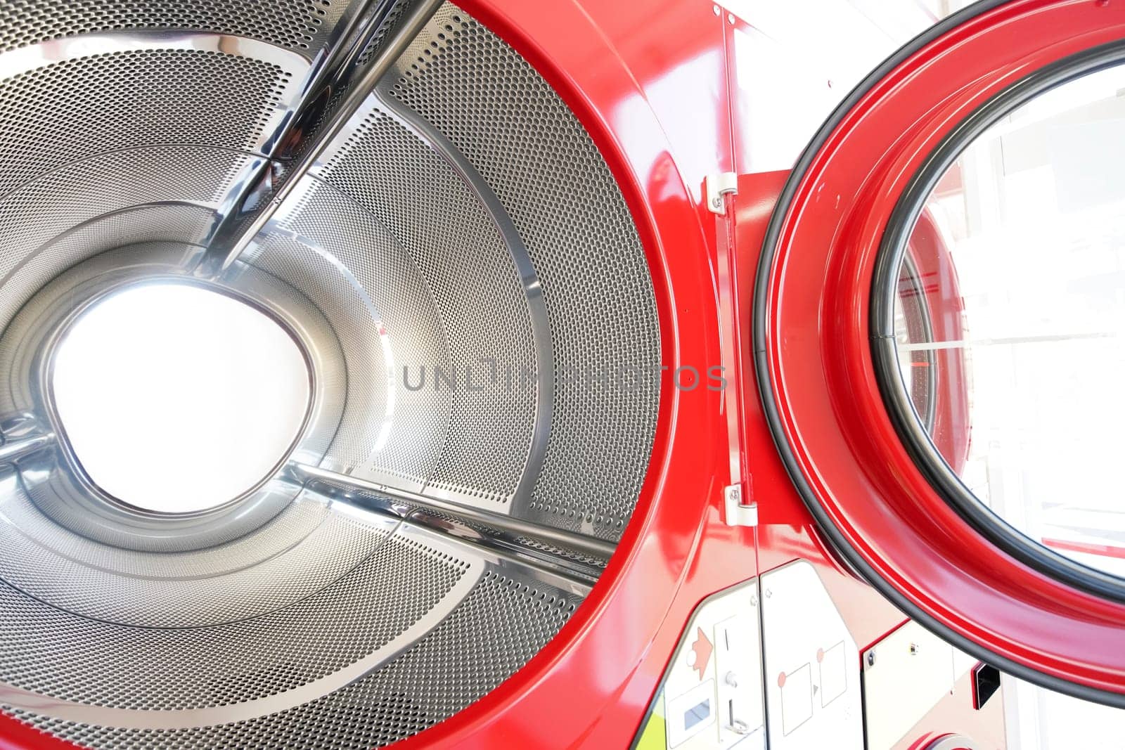 close up of industrial laundry machine in a public laundromat