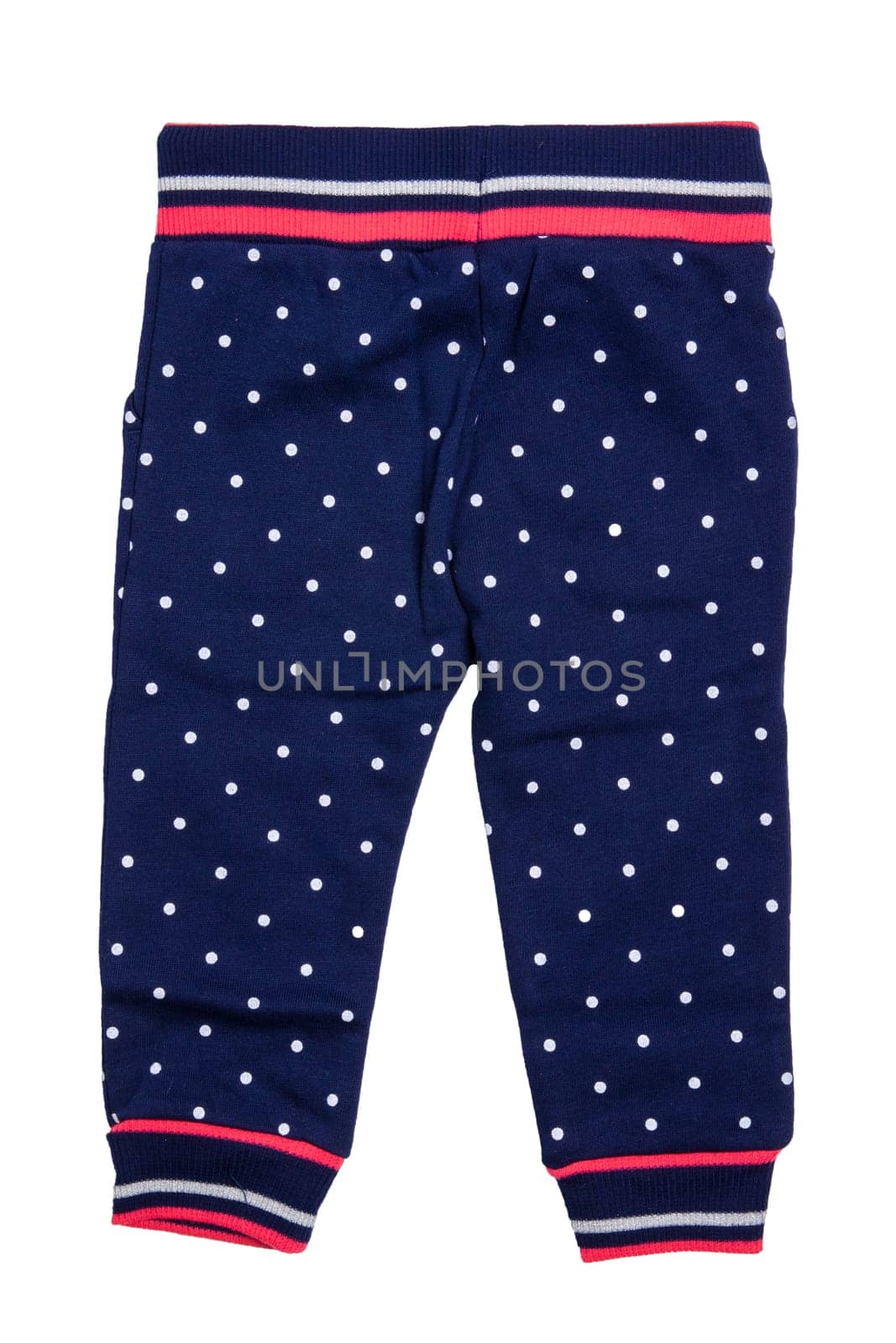 Kids pants isolated. A stylish fashionable dark blue denim trousers with white dots for the little girl. Children sport trousers. Back view.