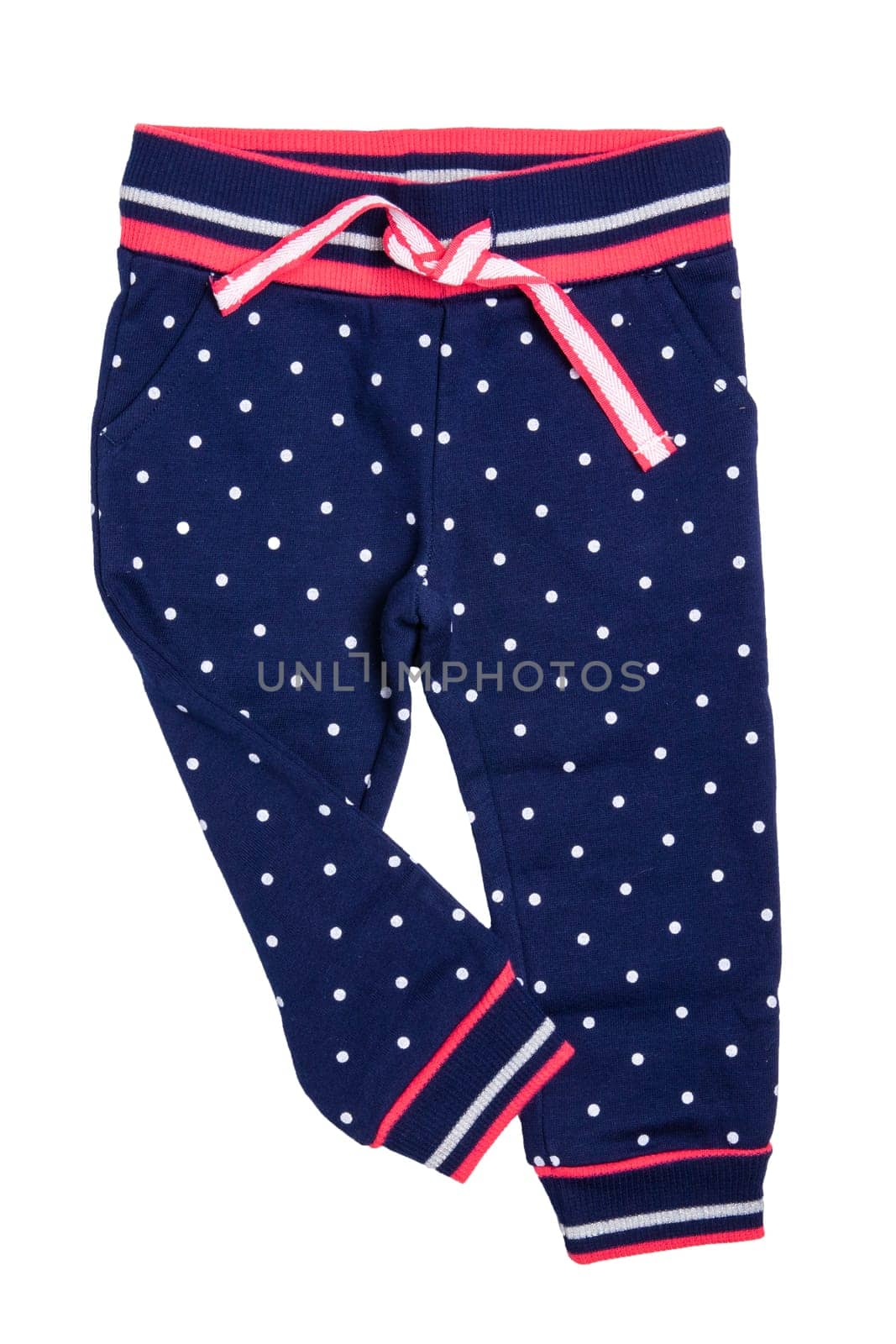 Kids pants isolated. A stylish fashionable dark blue denim trousers with white dots for the little girl. Children sport trousers.