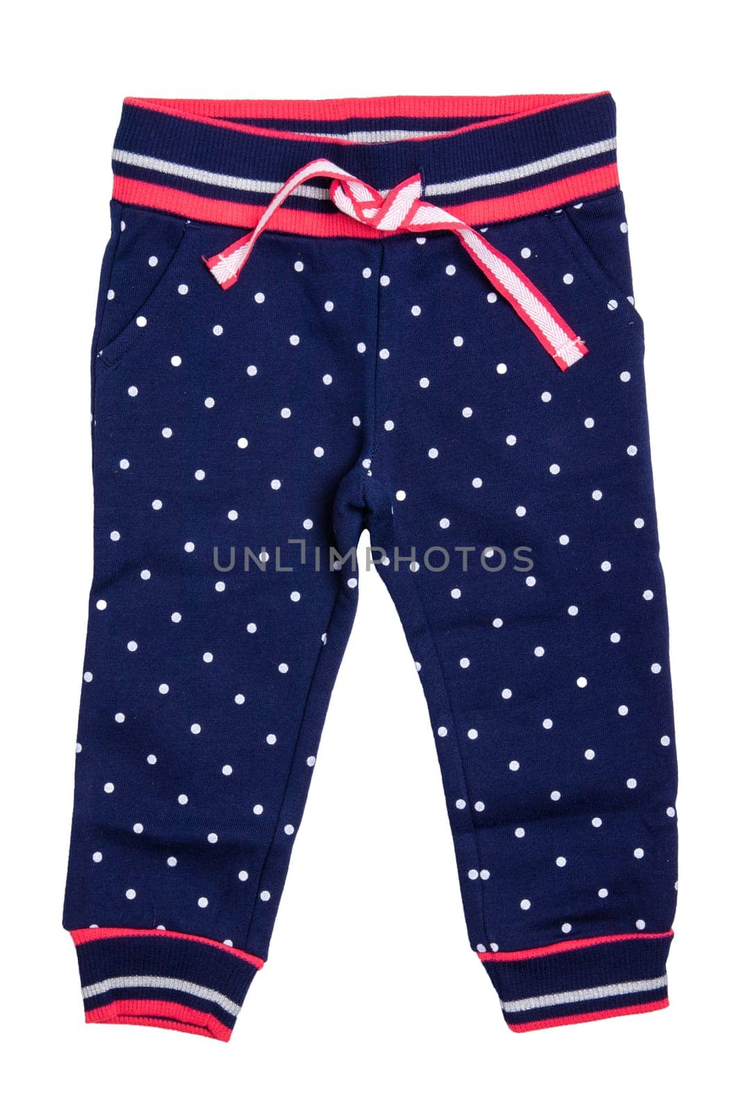 Kids pants isolated. A stylish fashionable dark blue denim trousers with white dots for the little girl. Children sport trousers.