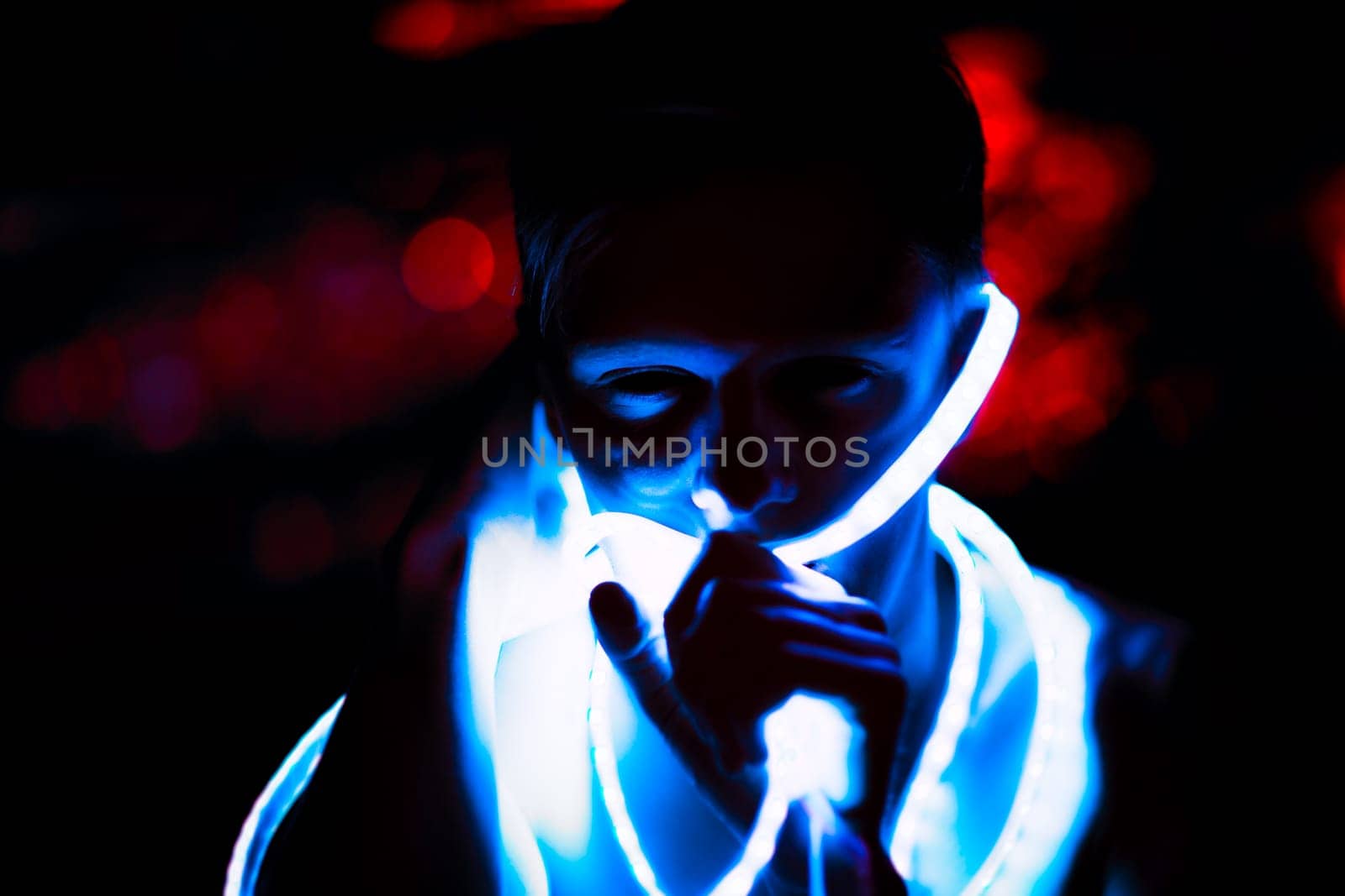 Portrait man Strip Light LED tape on dark color background.