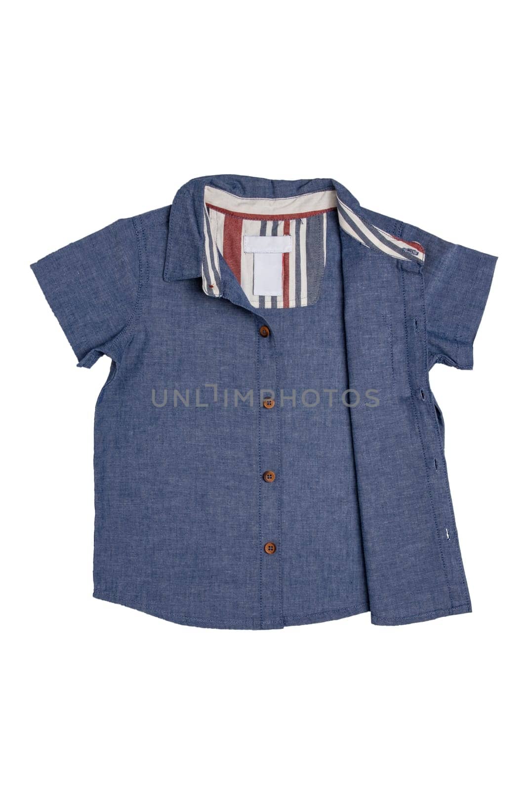 Denim shirts isolated. Close-up of a stylish blue jeans shirt for kids isolated on a white background. Summer fashion.