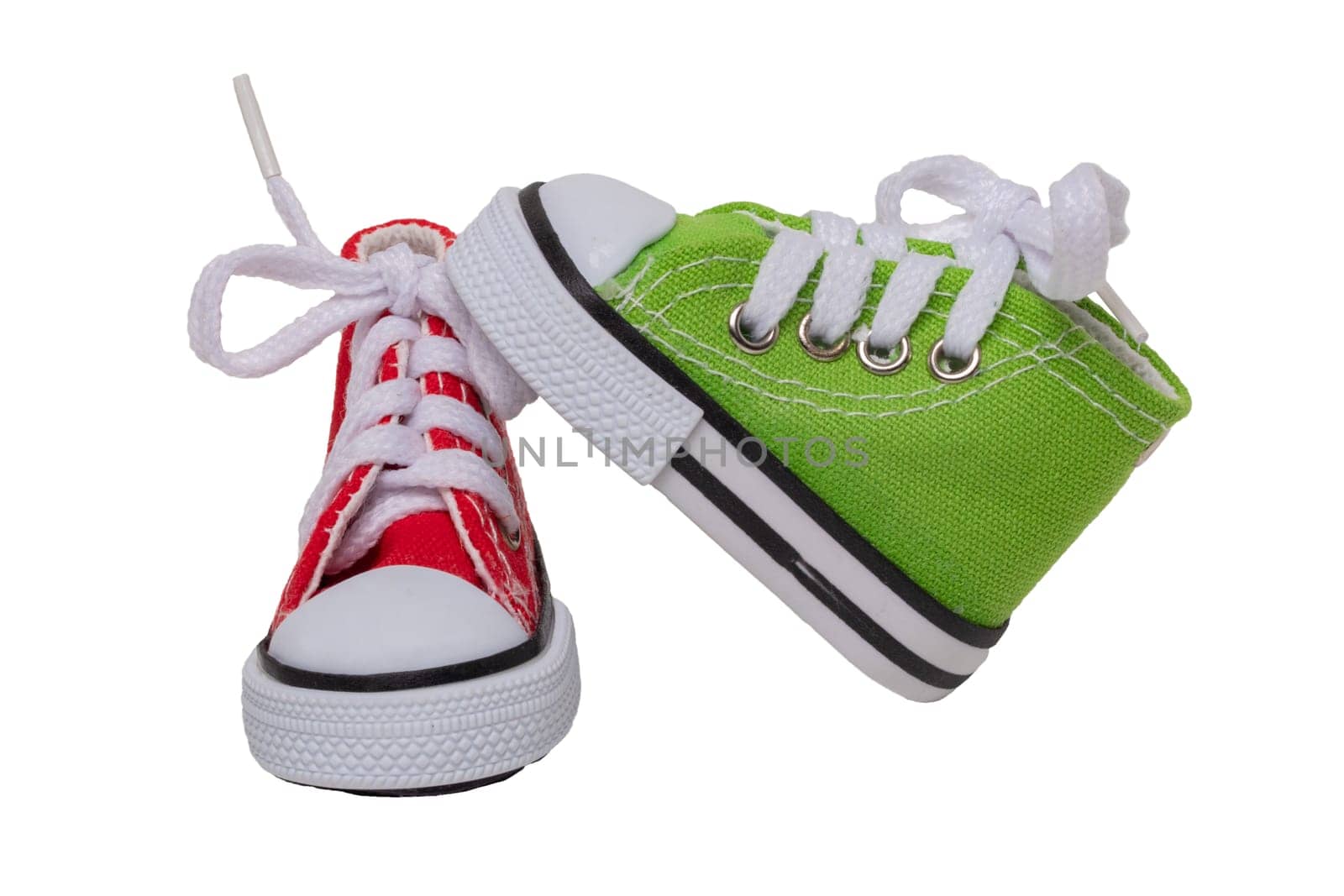 Shoes decorations background. Closeup of small colorful toy cloth shoes isolated on white background. Macro.