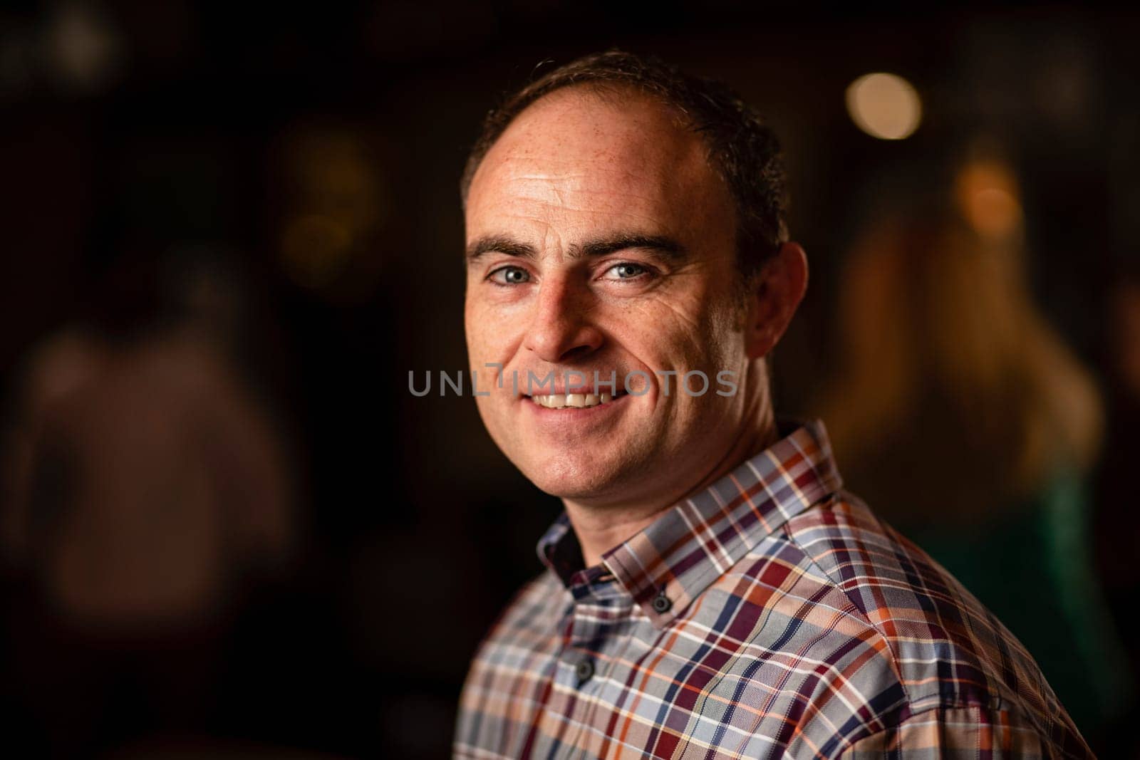 Headshot of a mature man smiling and looking at the camera.