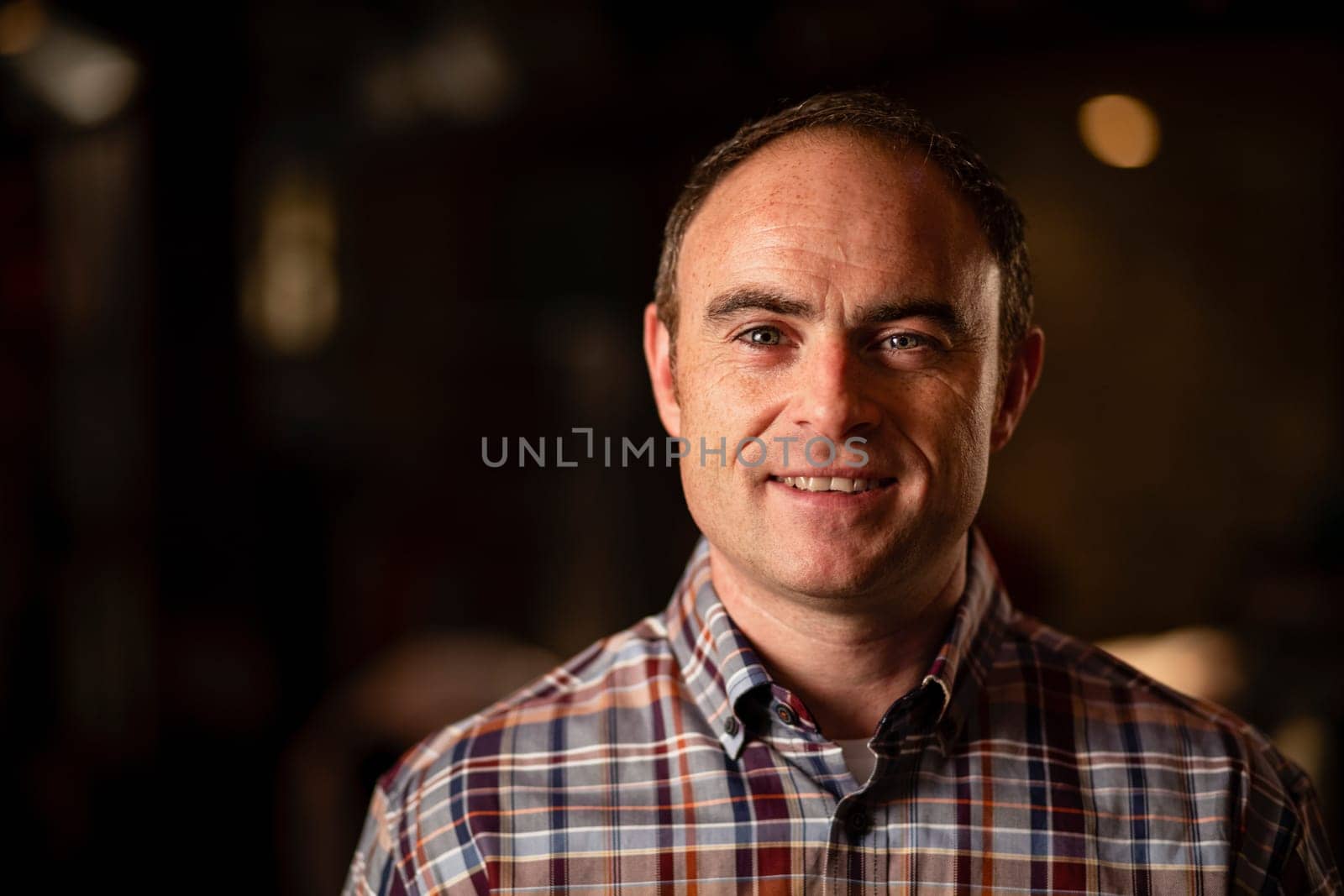 Headshot of a mature man smiling and looking at the camera.