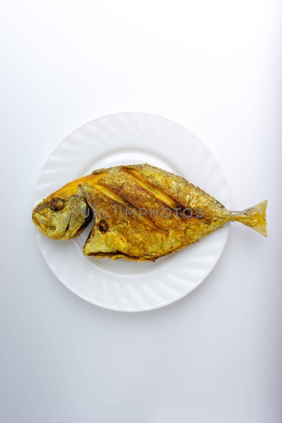 Fried fish on white background with selective focus