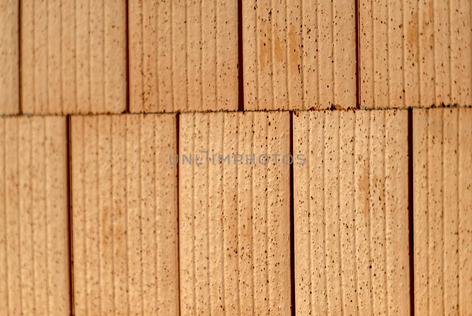 Red brick wall on a construction site with blurred areas as a background