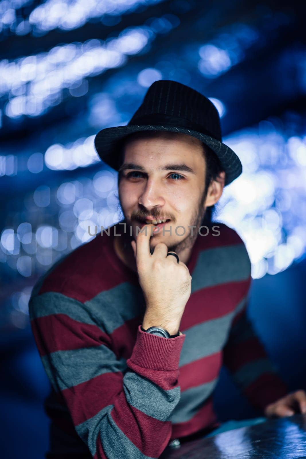 portrait of a guy in a hat on a blurred background.