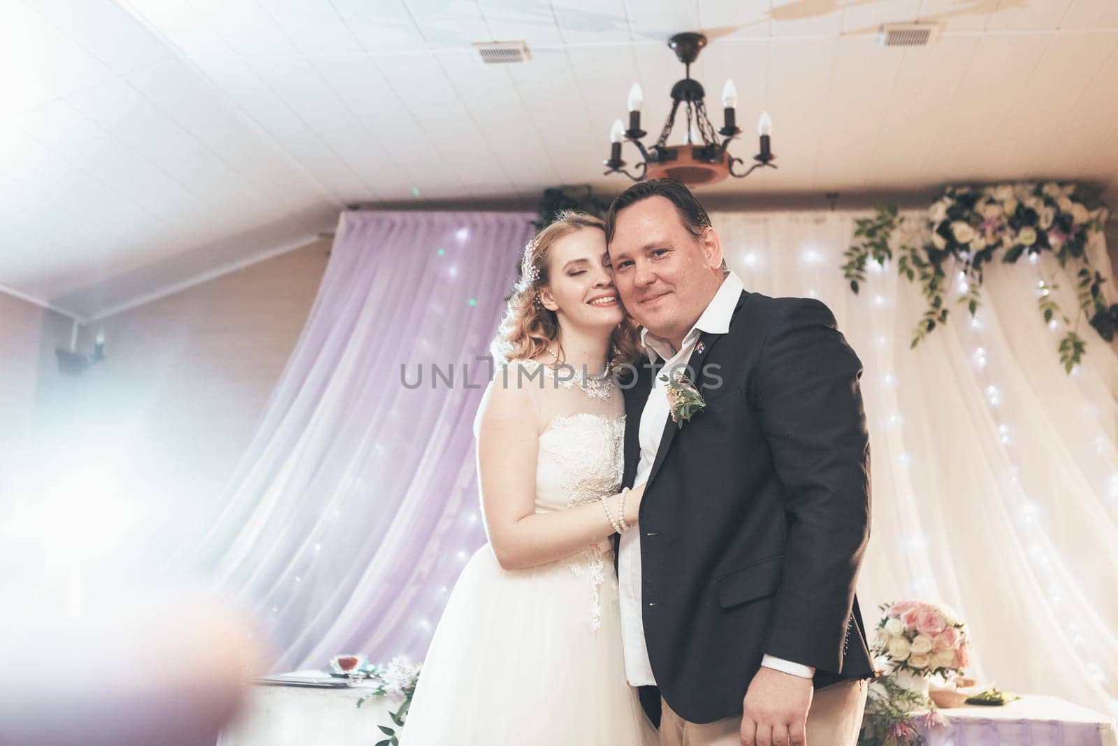 bride and groom first dancing on background a restaurant.