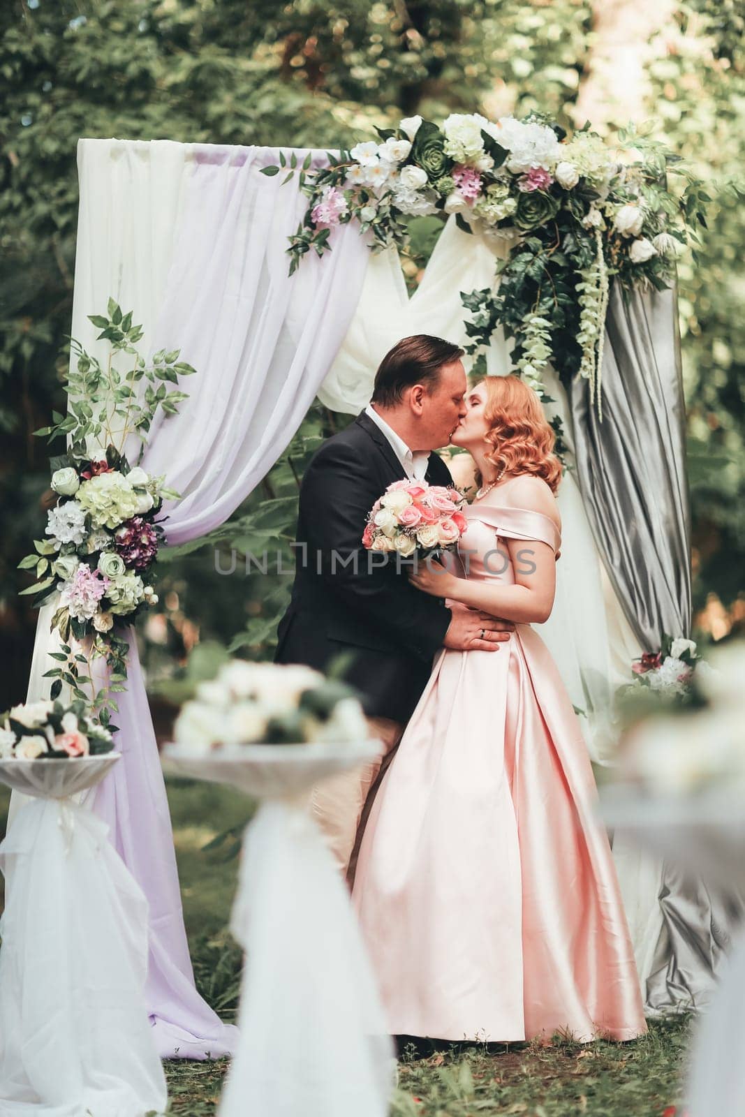 bride and groom on wedding ceremony on background nature.