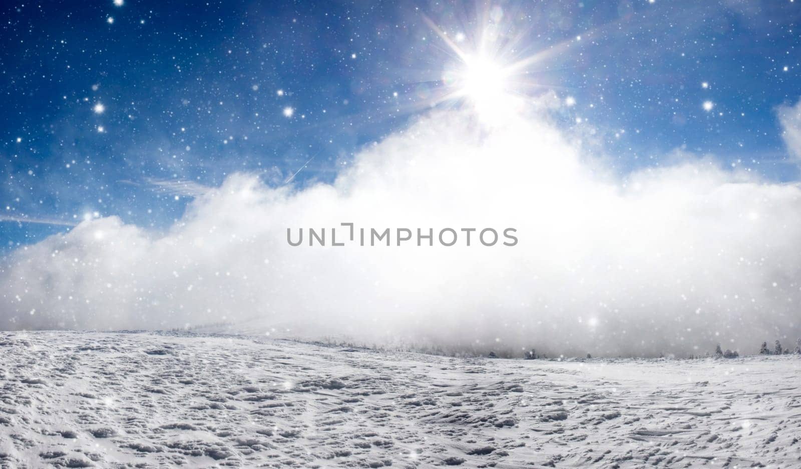 Winter landscape with snow covered hill and cloudy blue sky