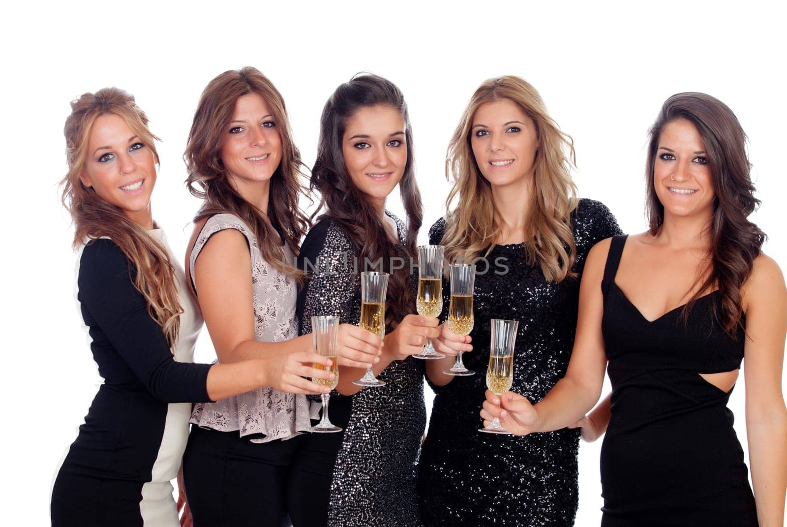 Group of pretty friends toasting with champagne in a celebration during christmas