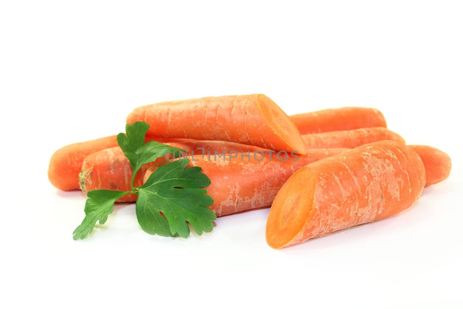 orange carrots with petersile against a white background