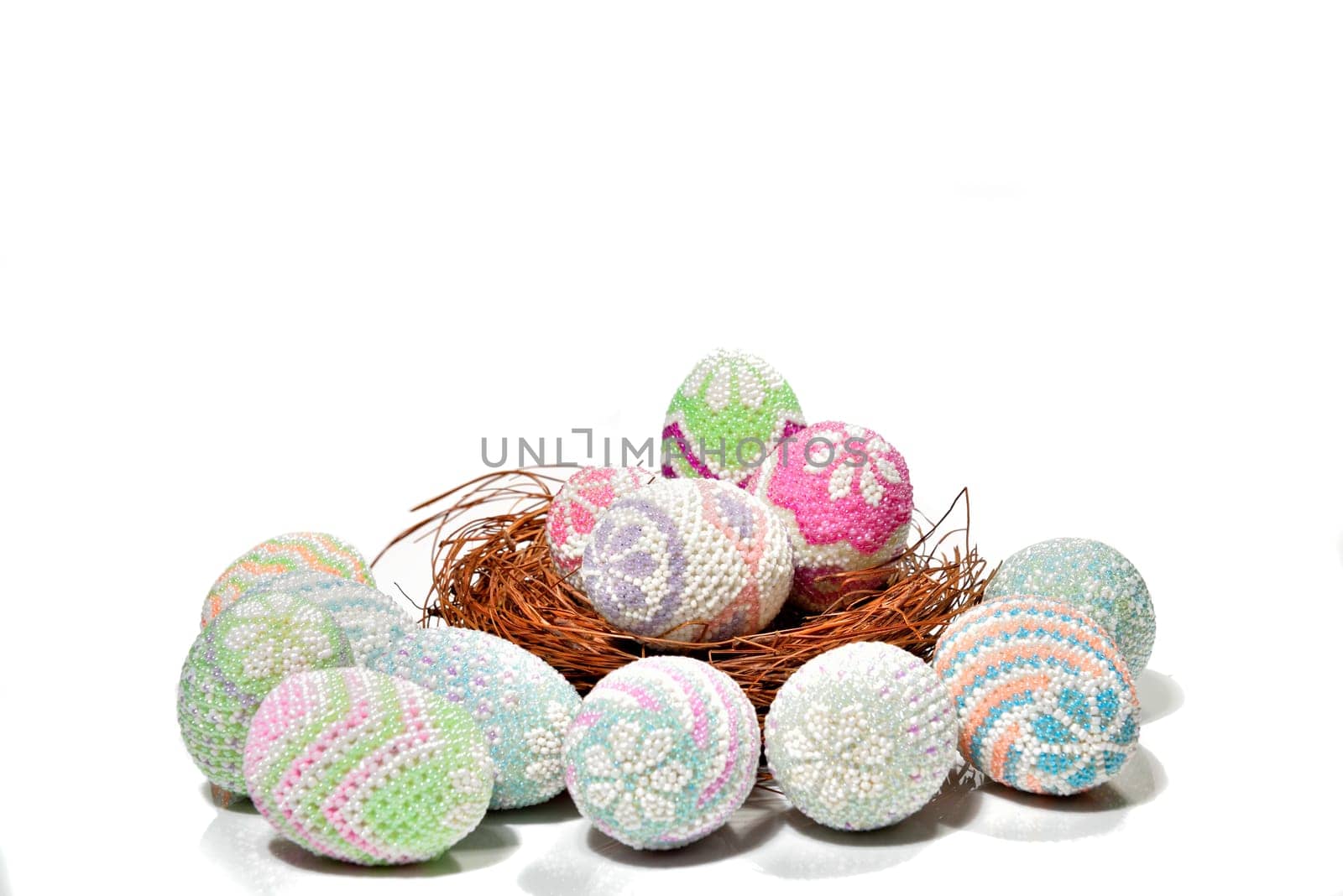 Colorful easter eggs in the nest and floor over white background. Happy Easter