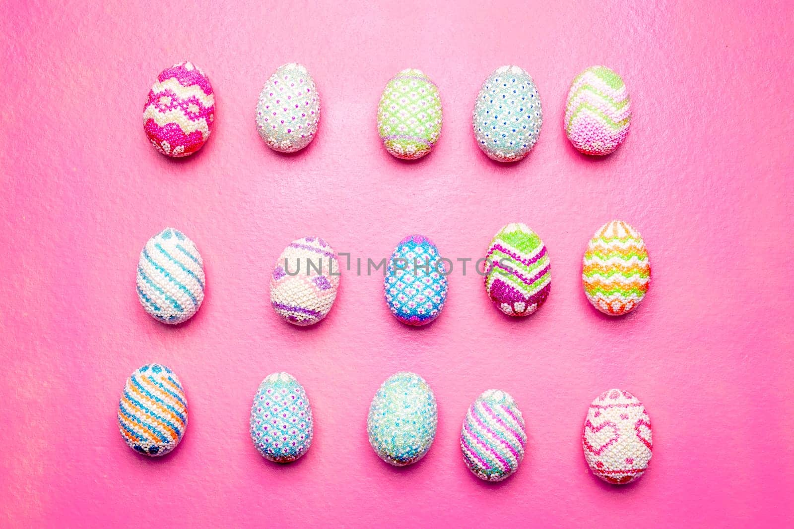 Row of Colorful easter eggs on the pink background. Happy Easter