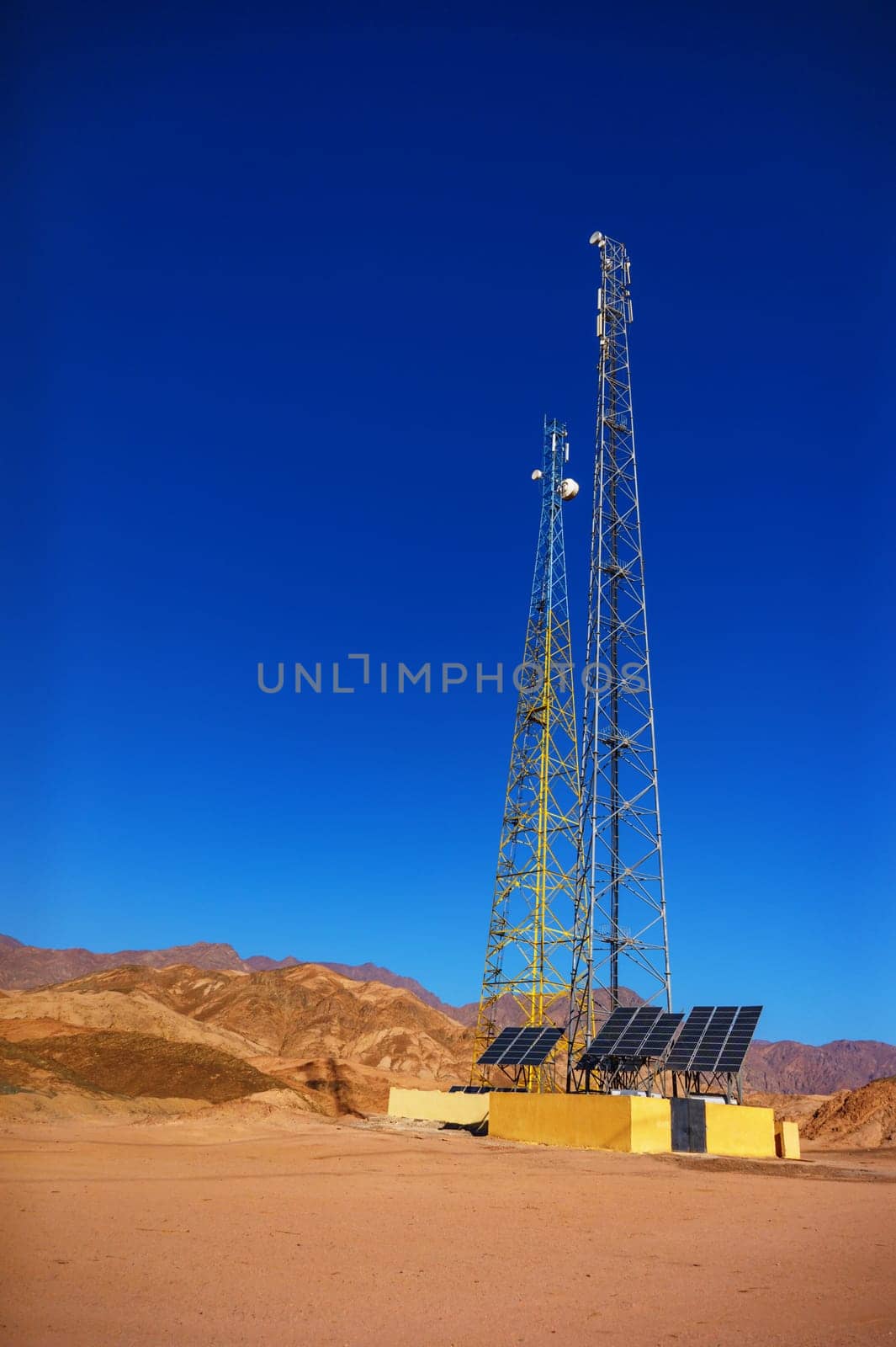 gsm towers with solar panels in the mountains