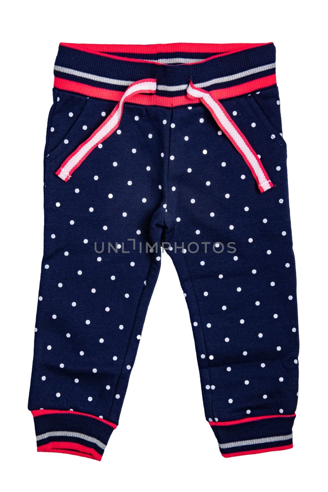 Kids pants isolated. A stylish fashionable dark blue denim trousers with white dots for the little girl. Children sport trousers.