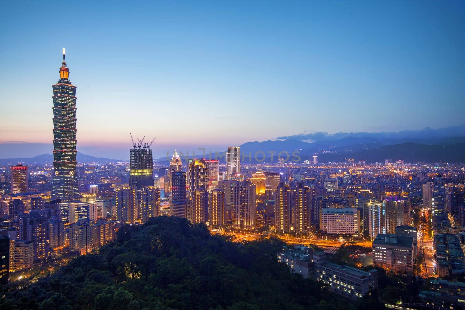 The Color cityscape with skyscraper and buildings under blue sky in night in Taipei Taiwan