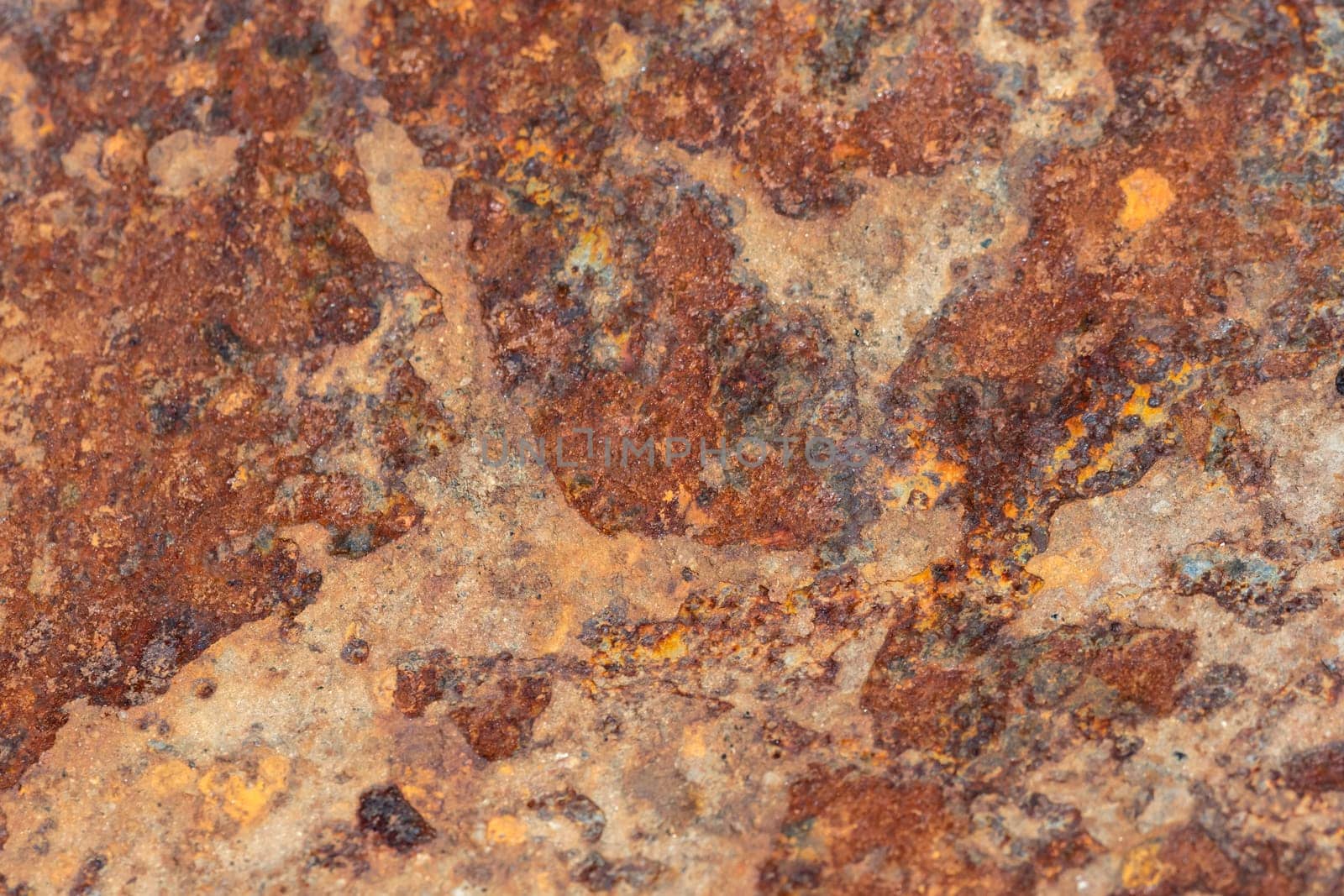 Brown tin wall with rust and peeled paint as a background