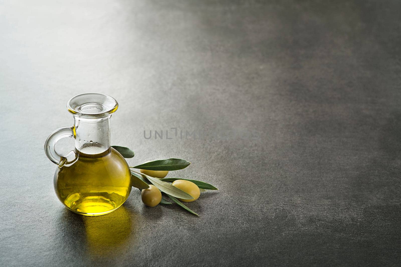 Bottle of Extra virgin healthy Olive oil with fresh olives
